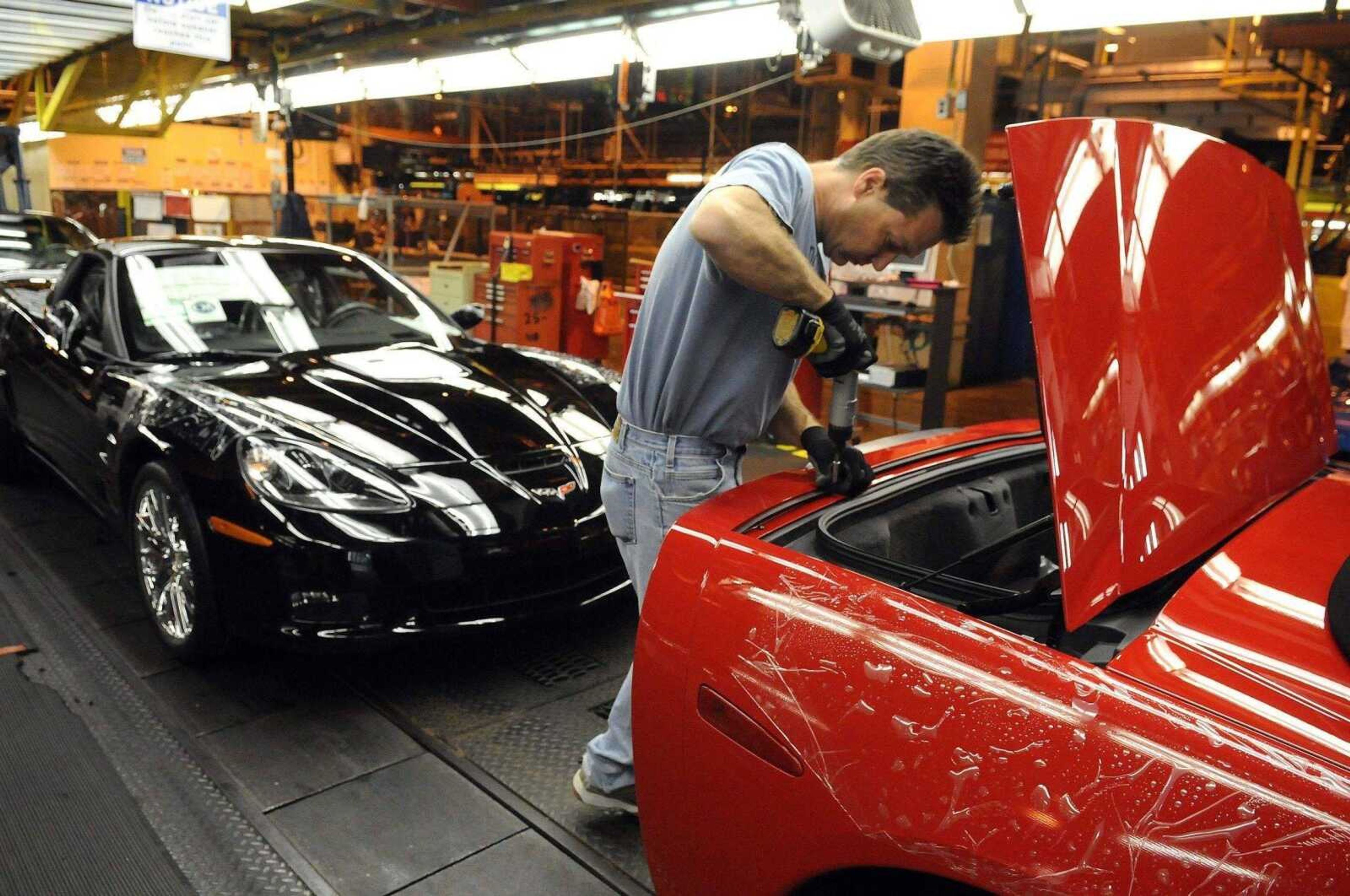 Joe Imel ~ Daily News<br>General Motors Corvette assembly plant worker Scott Campbell puts the finishing touches on a Corvette Dec. 12 at the Bowling Green, Ky., plant. In survival plans submitted Tuesday, General Motors Corp. and Chrysler LLC are asking for billions more to stay afloat.