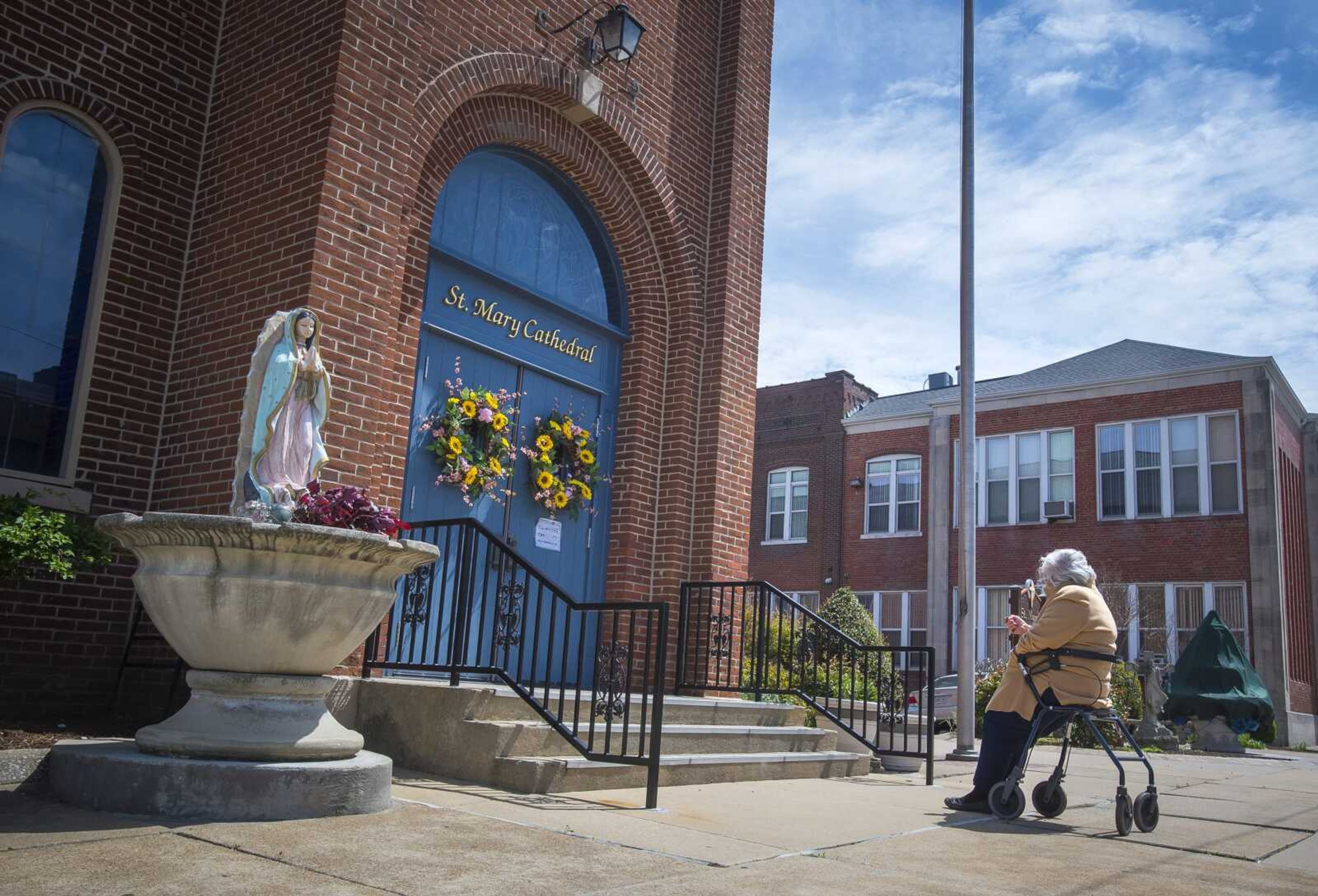 While the church remained closed, one churchgoer sat outside of St. Mary's Cathedral to pray the rosary Monday, April 13, 2020, in Cape Girardeau. The prayer asked to remain anonymous, but said her actions were  a non-violent protest against everything going on  as she prayed for the health of all.