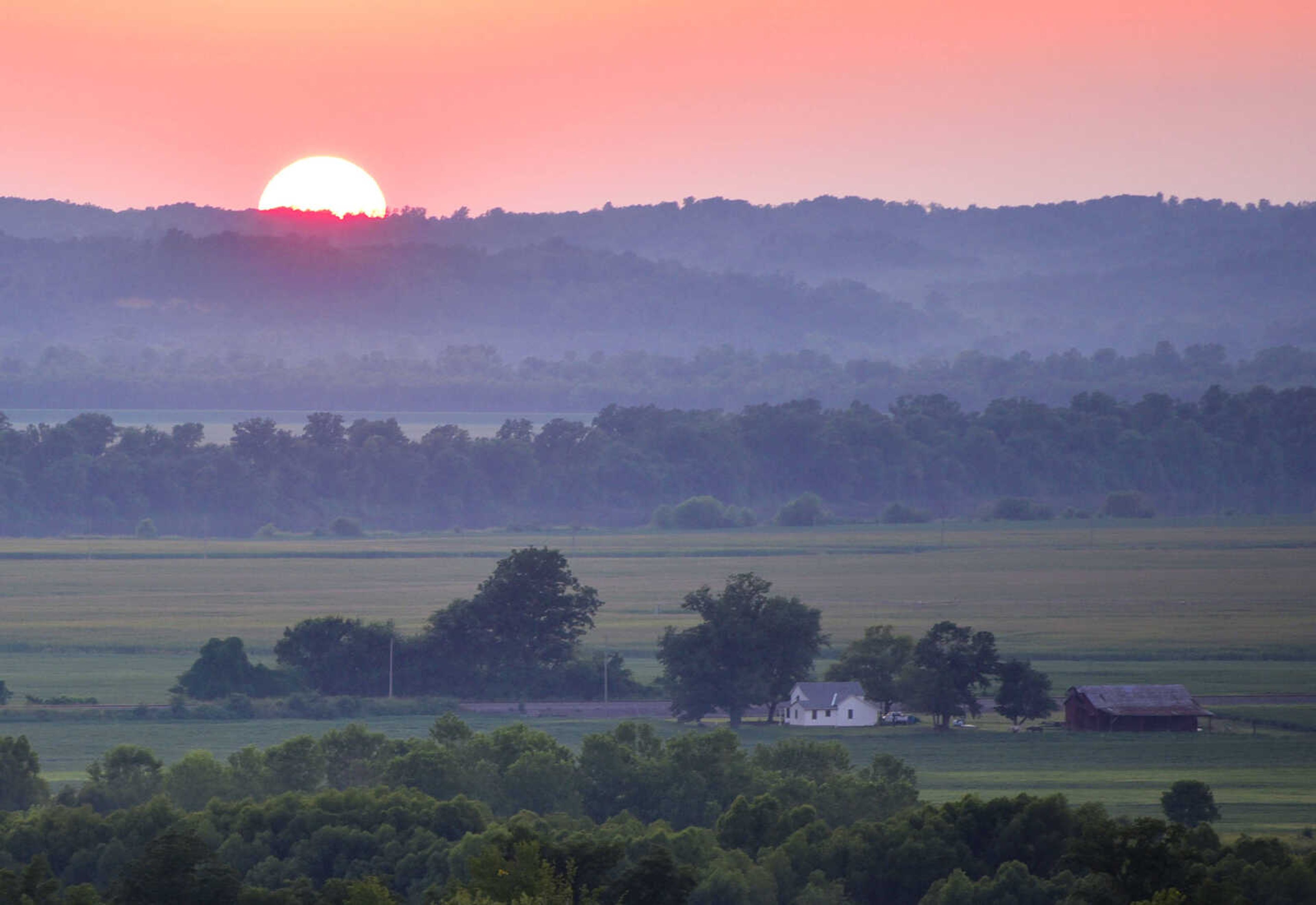 The sun is seen from the Inspiration Point overlook as it sets behind the horizon Wednesday, Aug. 1, 2018, near Wolf Lake, Illinois.