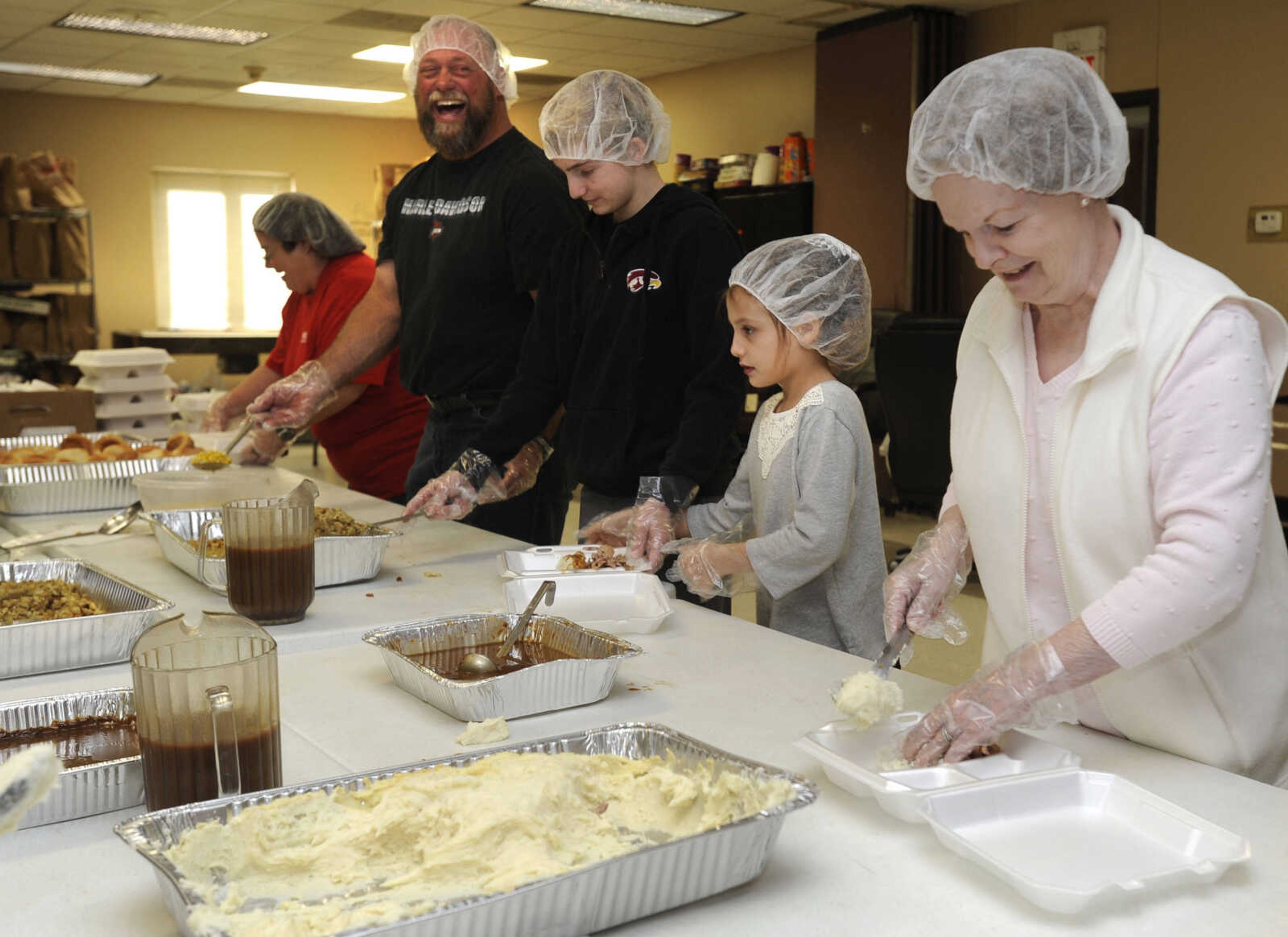 FRED LYNCH ~ flynch@semissourian.com
Volunteers prepare turkey dinners for delivery Thursday, Nov. 23, 2017 at the Thanksgiving Day luncheon at the Salvation Army in Cape Girardeau.