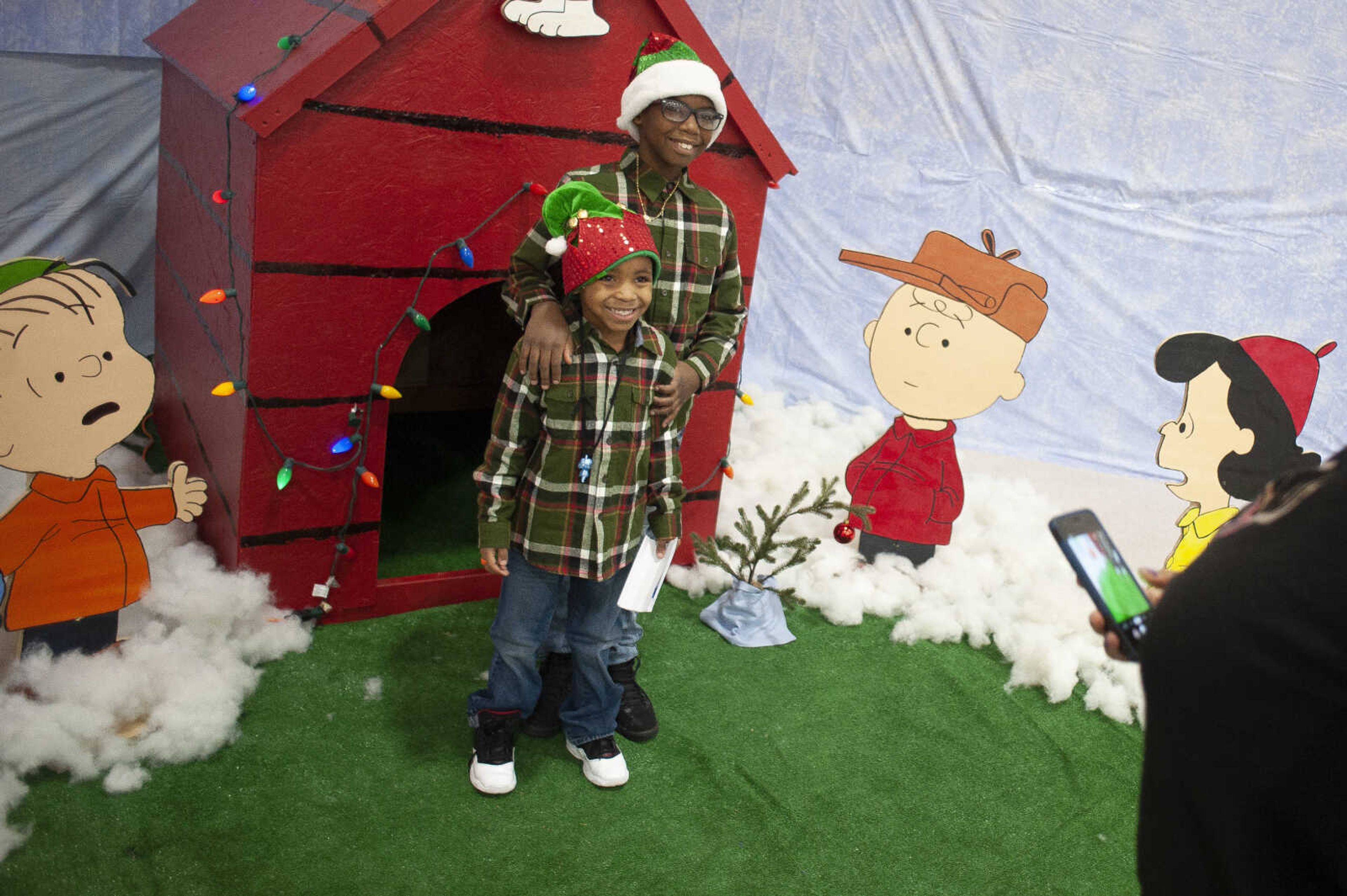 Damarien Williams, 10, and Lance Lewis, 5, (with red on hat) smile for their mother Danielle Williams of Cape Girardeau during the Cape Parks &amp; Recreation Foundation's Breakfast with Santa event Saturday, Dec. 14, 2019, at the Osage Centre in Cape Girardeau.