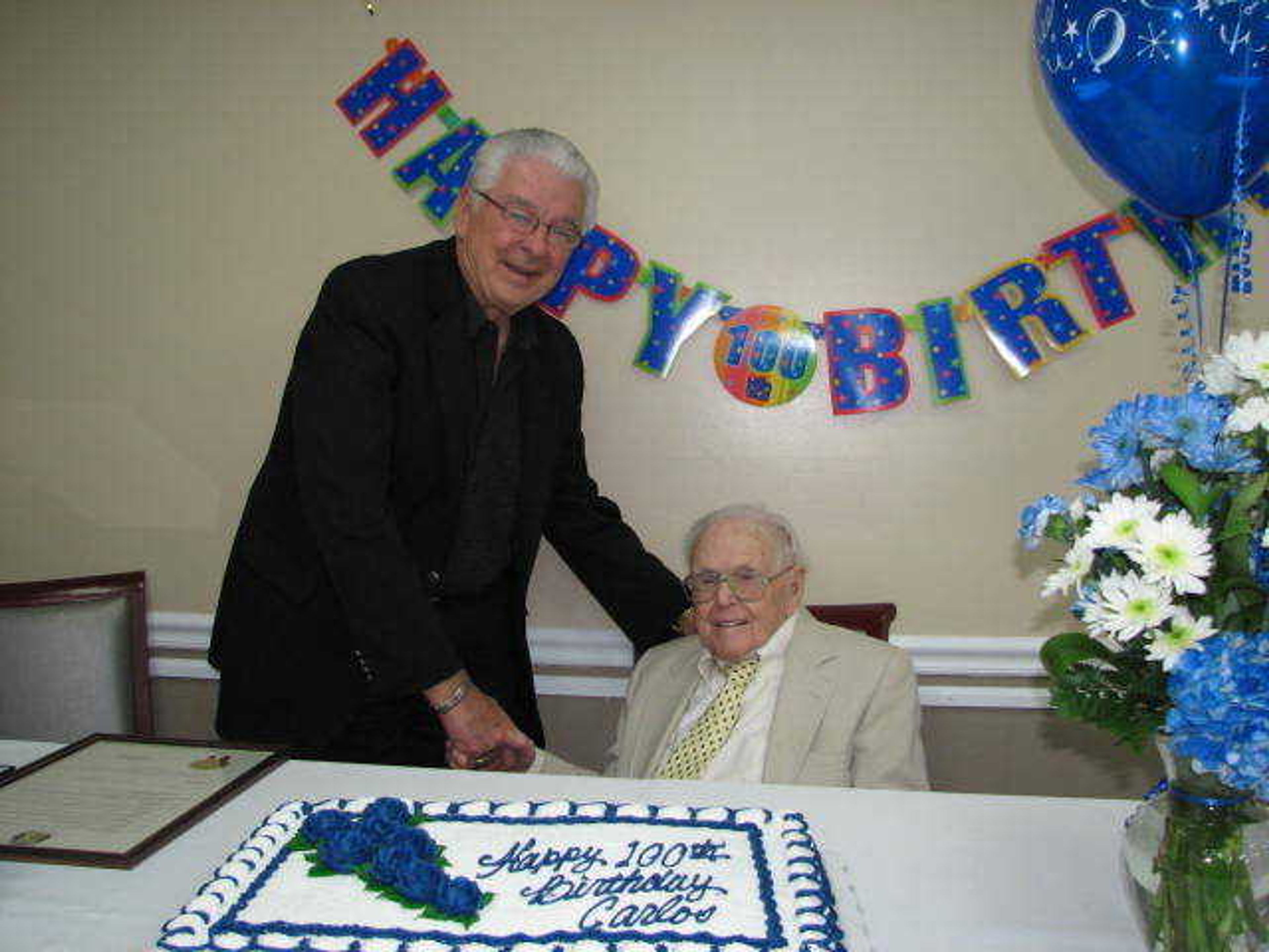 Cape Girardeau Mayor Harry E. Rediger shakes the hand of Carlos Chitty during his 100th birthday celebration.