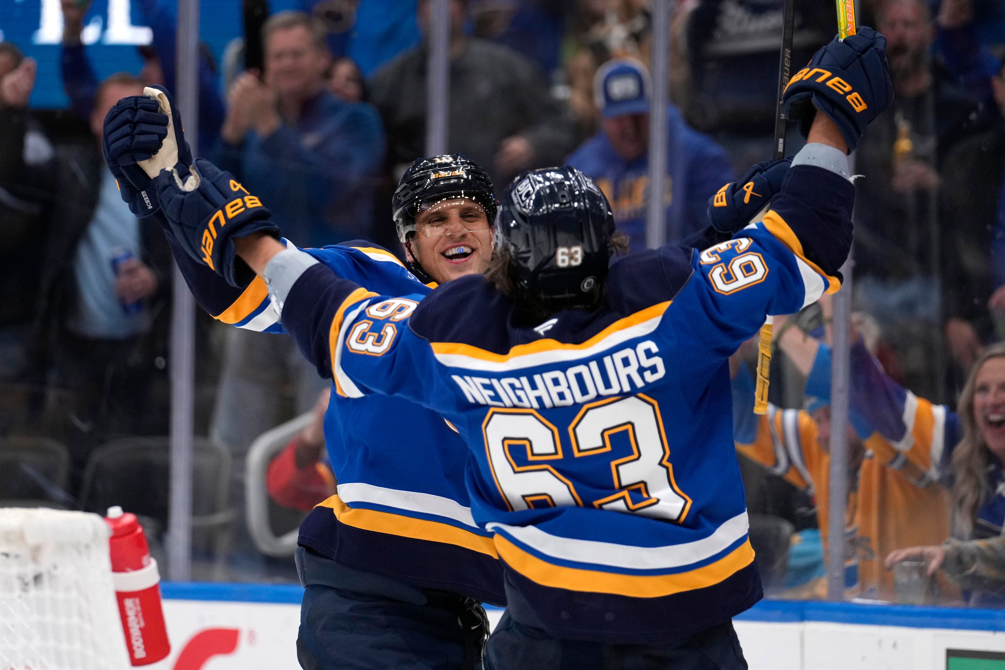 St. Louis Blues' Brayden Schenn is congratulated by Jake Neighbours (63) after scoring during the second period of an NHL hockey game against the Boston Bruins Tuesday, Nov. 12, 2024, in St. Louis. (AP Photo/Jeff Roberson)