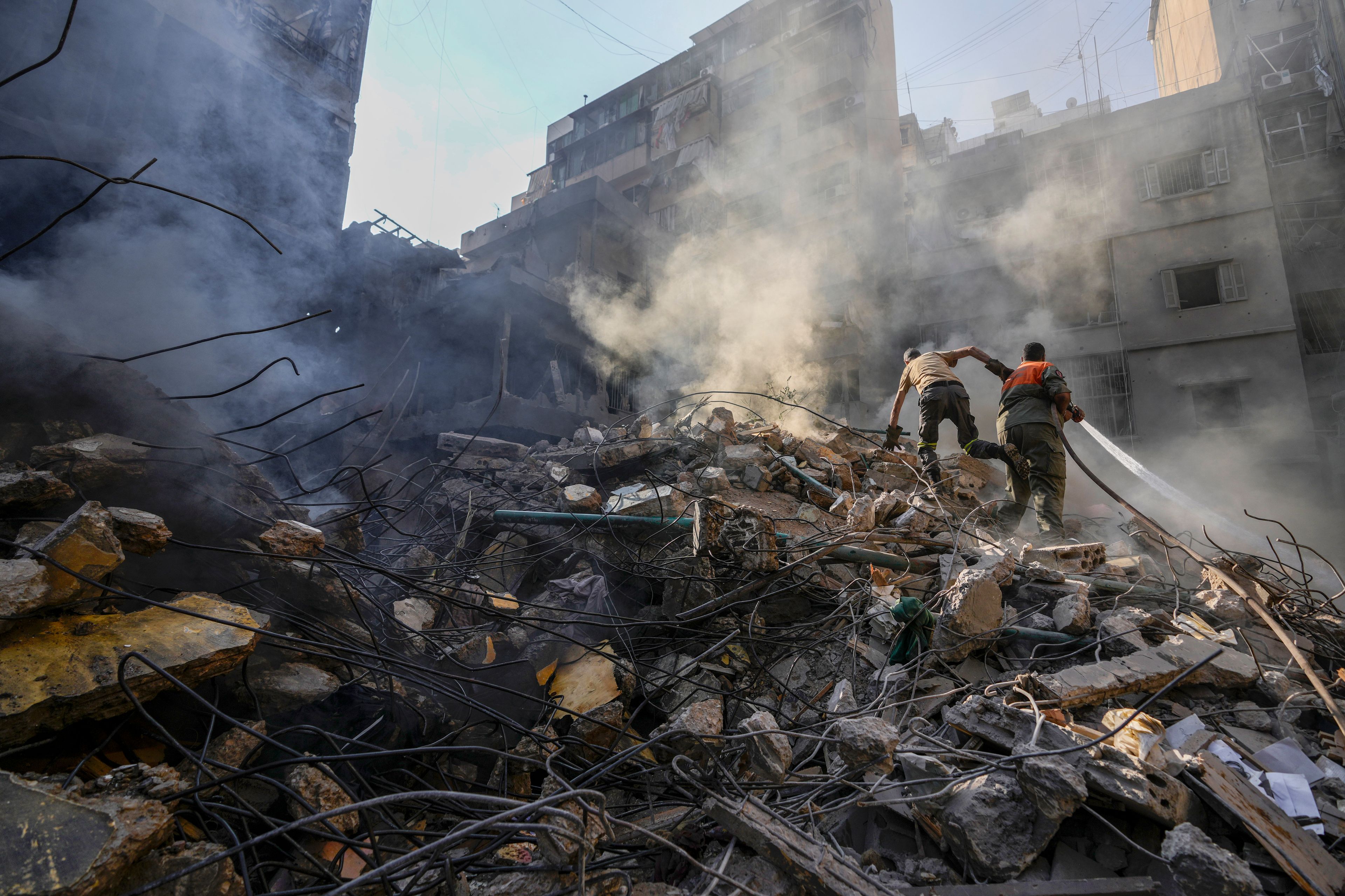 Rescue workers search for victims at the site of Thursday's Israeli airstrike in Beirut, Lebanon, Friday, Oct. 11, 2024. (AP Photo/Hassan Ammar)