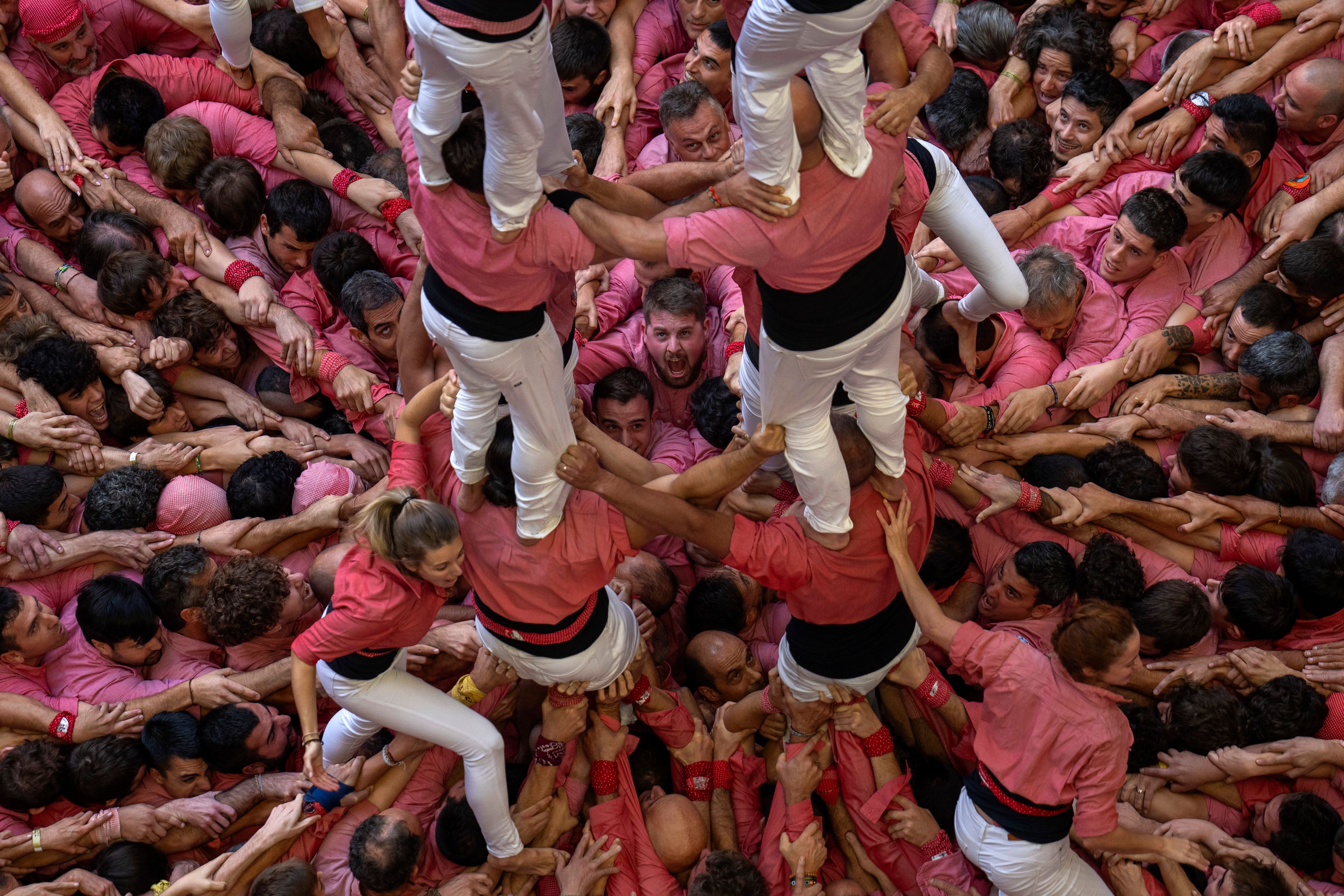 Members of "Vella de Valls" react after completing a "Castell" or human tower, during the 29th Human Tower Competition in Tarragona, Spain, Sunday, Oct. 6, 2024. (AP Photo/Emilio Morenatti)