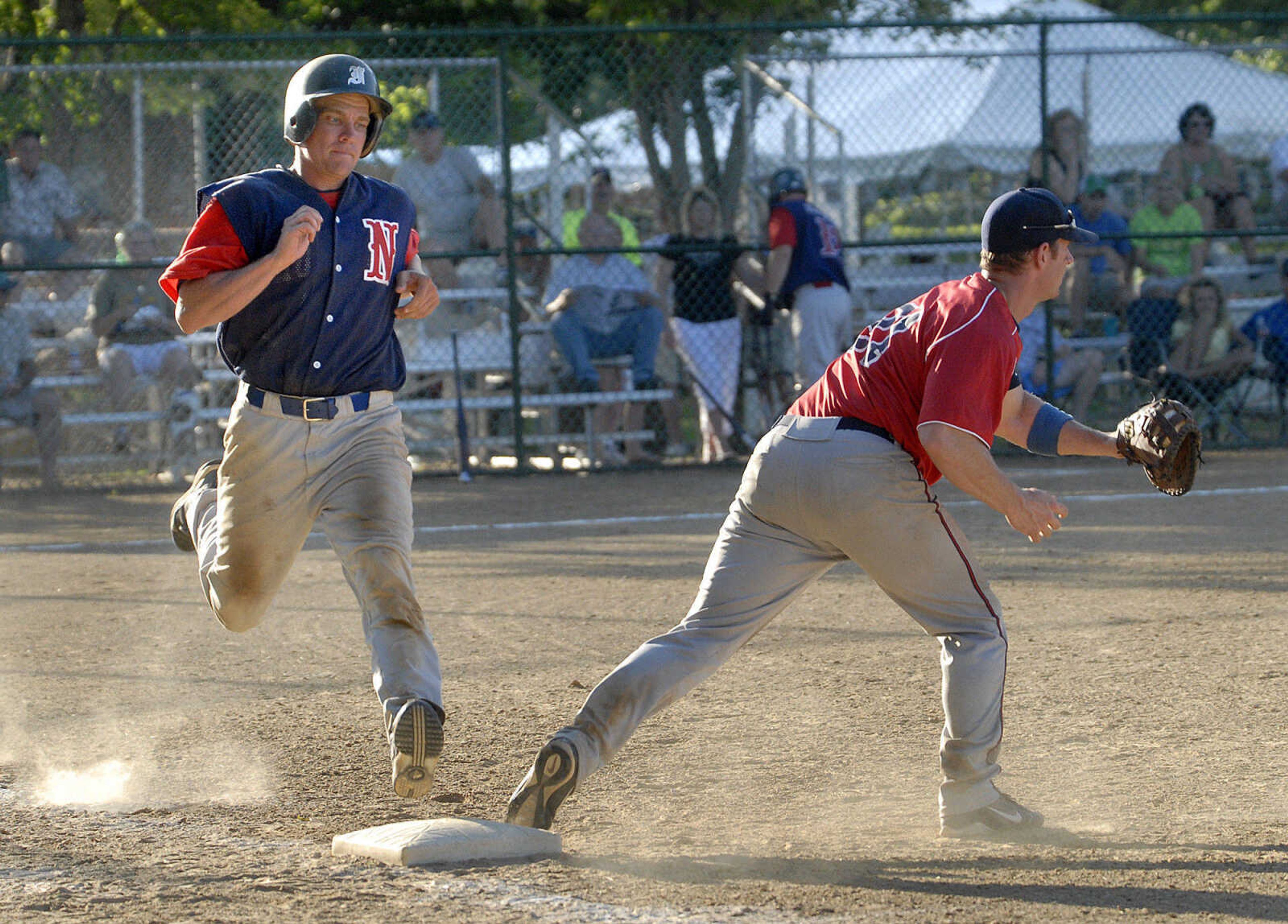 FRED LYNCH ~ flynch@semissourian.com
Nokomis Bud Light's Tom Meyers is out at first base as Decatur Pride's Doug Williams takes the throw during the third inning of the championship game Sunday at the Kelso Klassic.