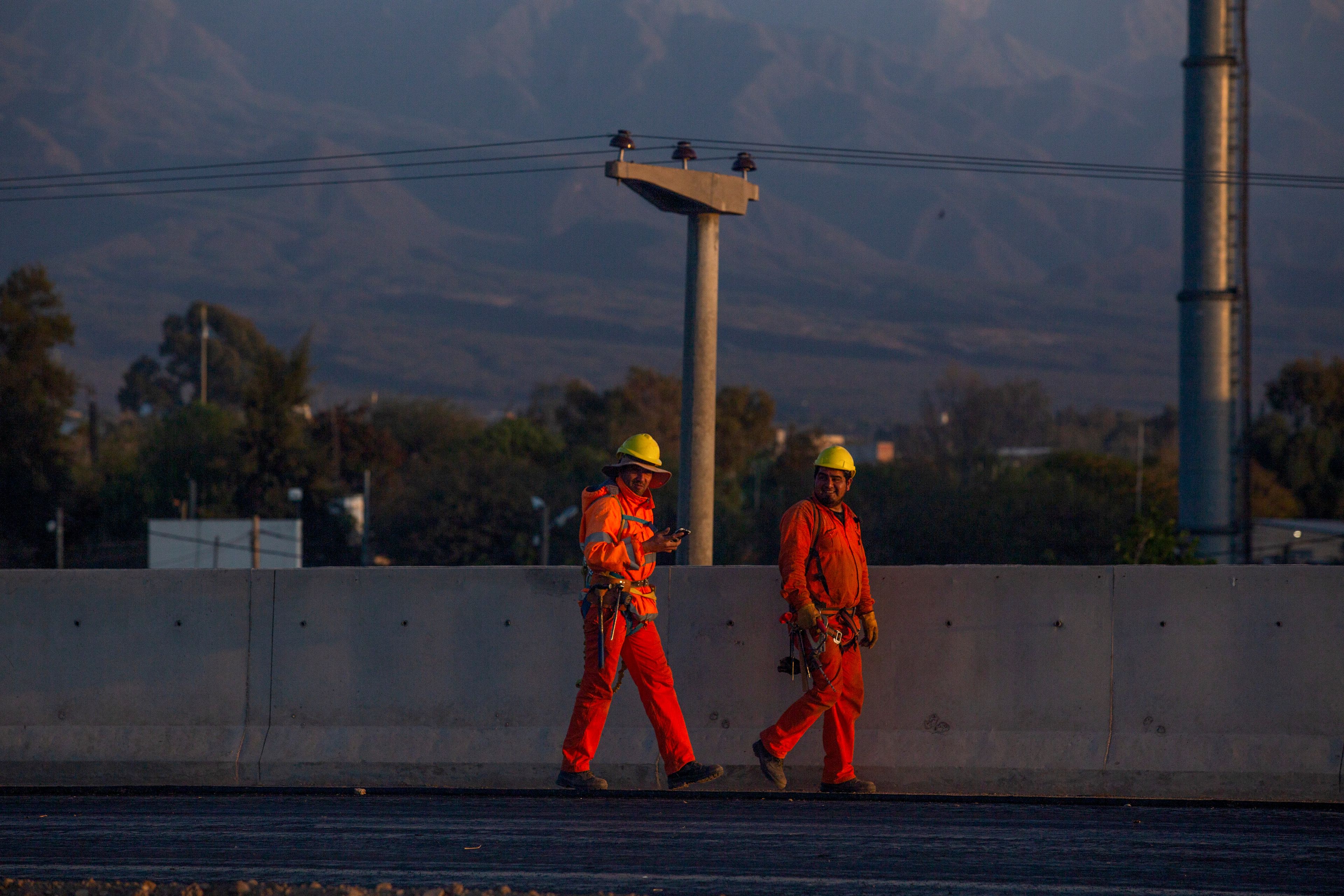 State workers head to work in La Rioja, Argentina, Friday, Sept. 13, 2024. In response to slashed federal budgets to provinces, La Rioja is printing a new emergency tender called "chachos" to pay state workers and spur the economy. (AP Photo/Natalia Diaz)