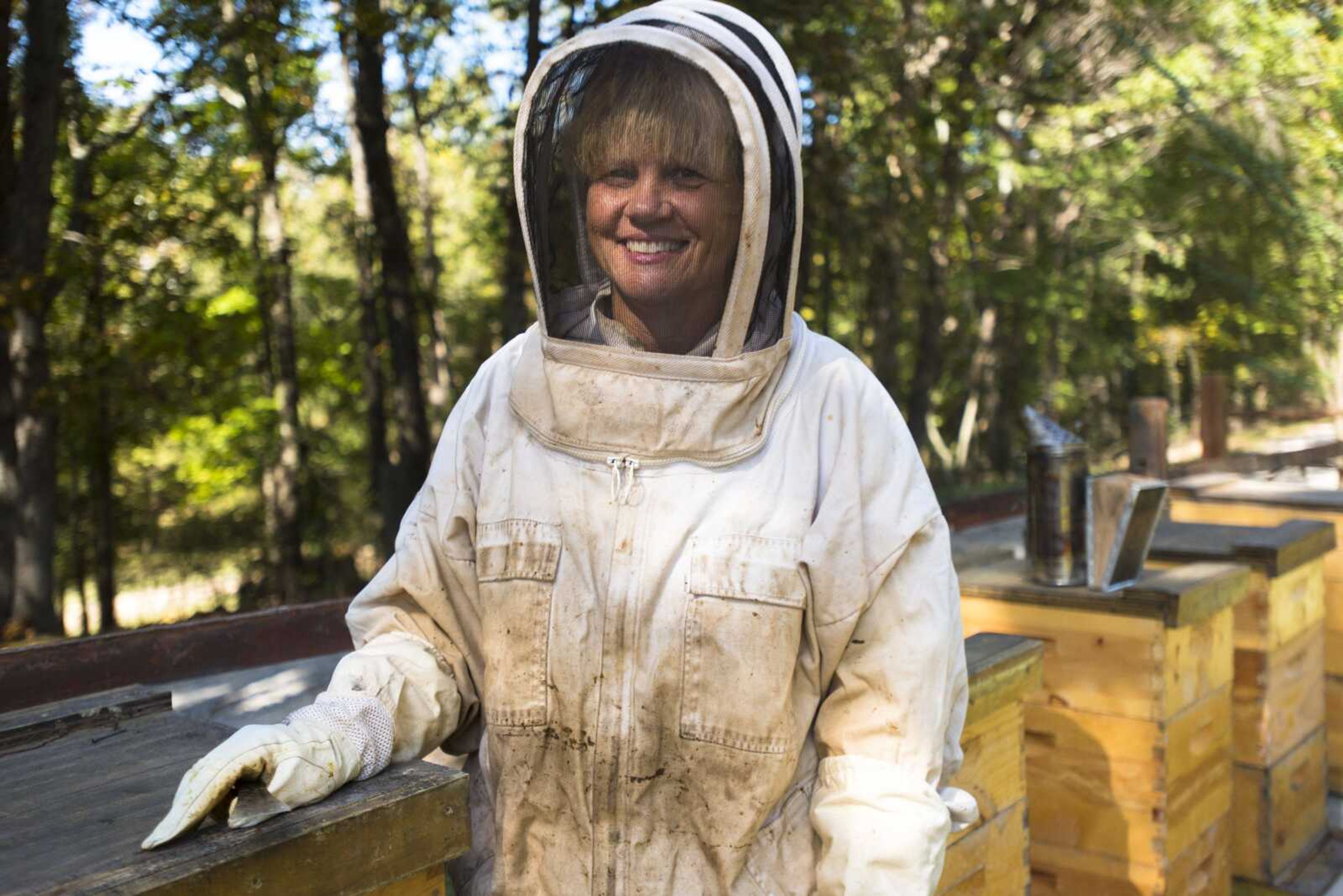 Fashion description:Carmen McNeely tends to her beehives Oct. 17 at her home in Fruitland.