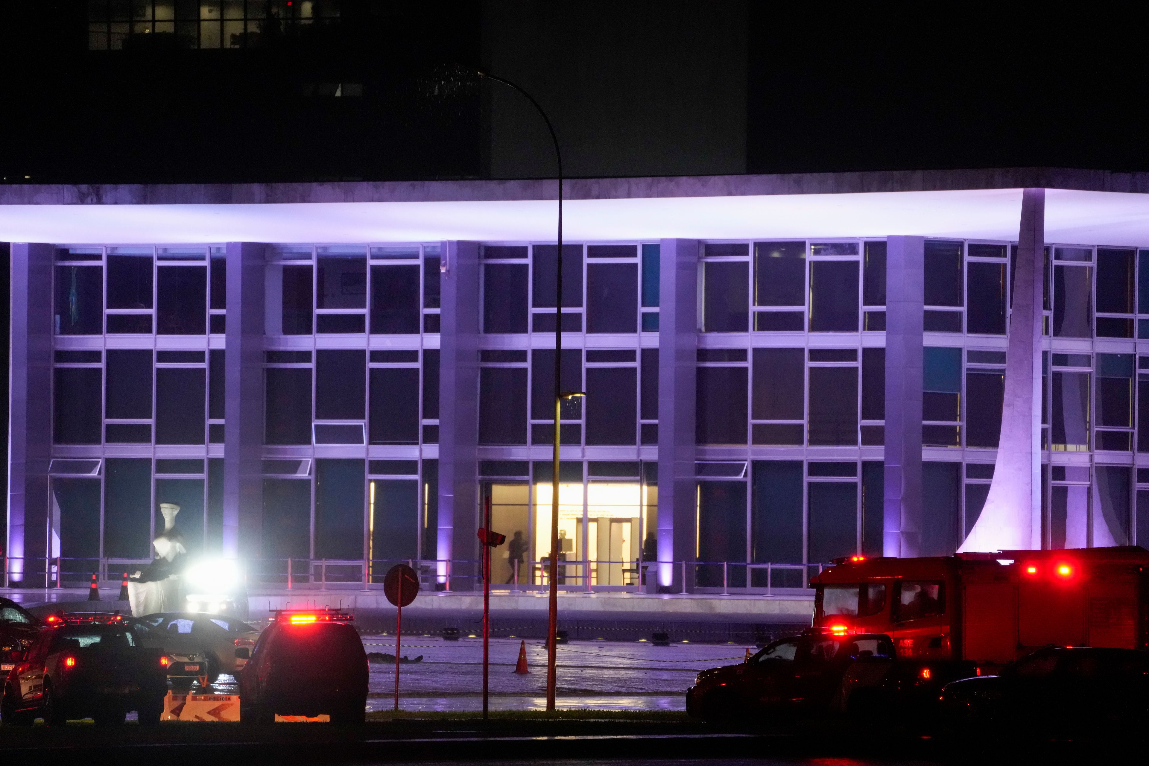 Police vehicles are parked outside the Supreme Court in Brasília, Brazil, following an explosion, Wednesday, Nov. 13, 2024. (AP Photo/Eraldo Peres)