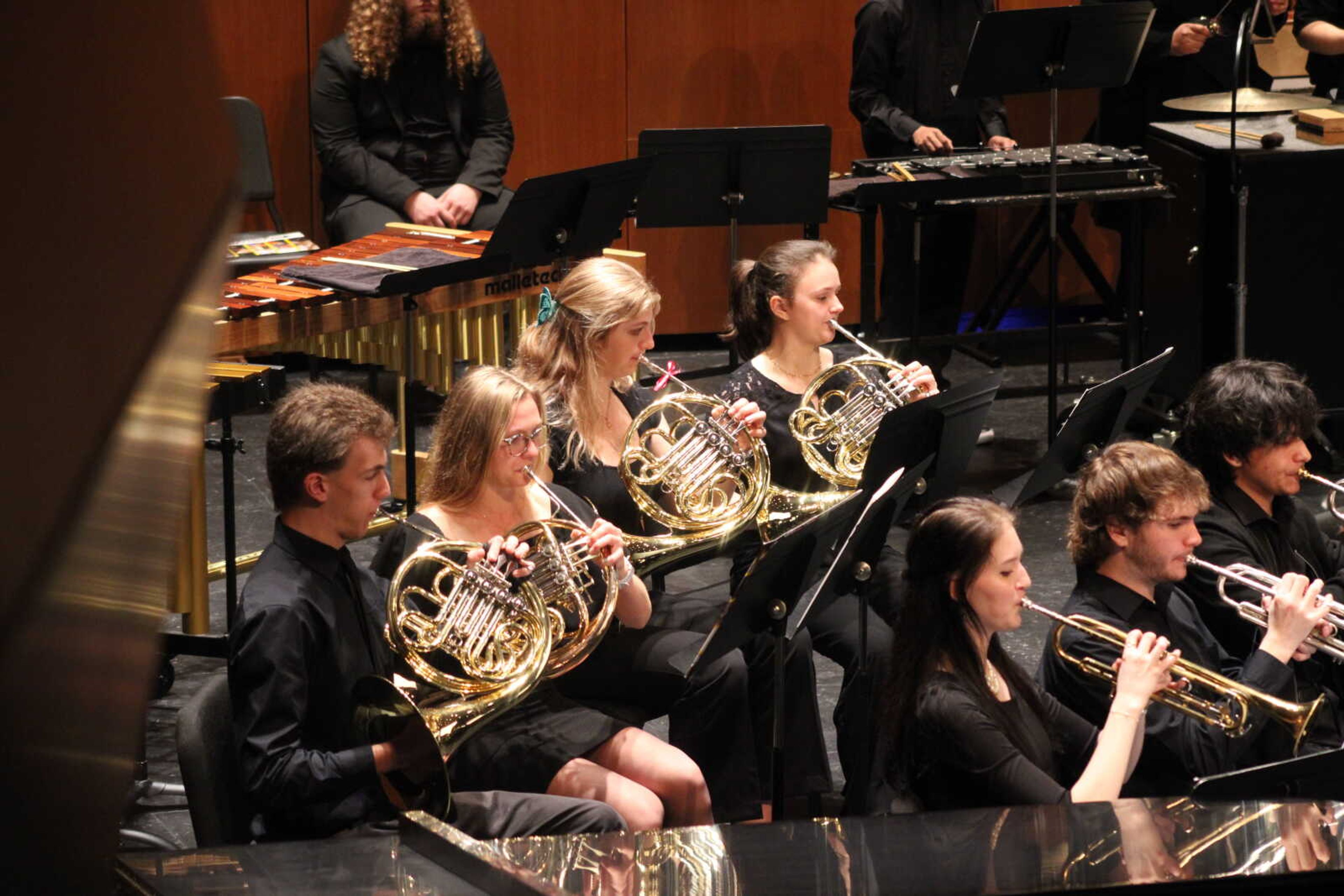 The French Horn section of the University Concert Band plays