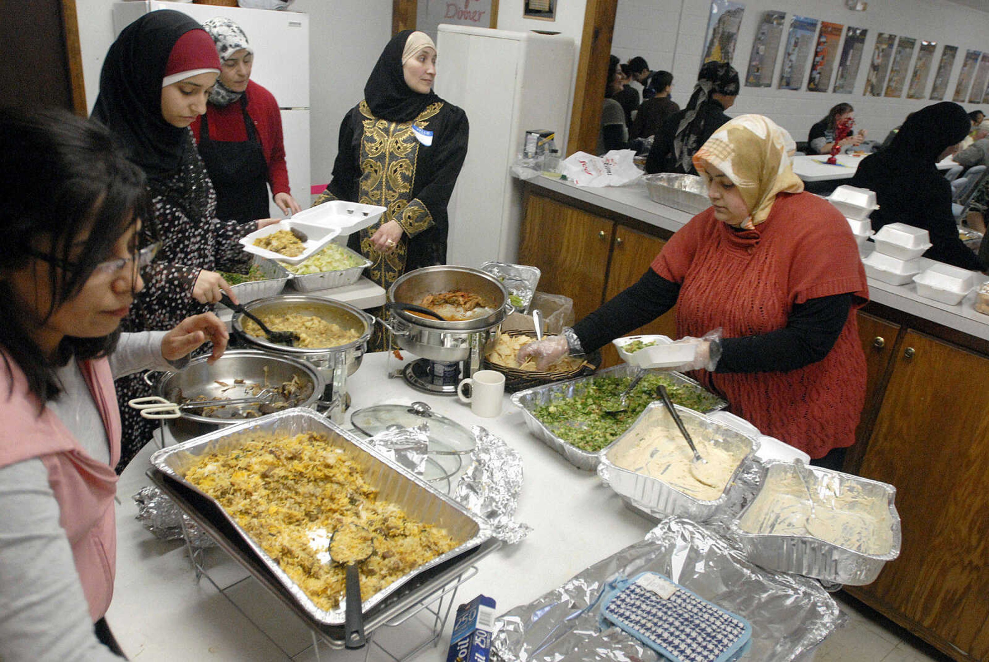 LAURA SIMON~lsimon@semissourian.com
Members of the Islamic Center in Cape Girardeau prepare carry-outs of biryani, tandori chicken, kabobs, tabola salad, hummus and pita chips Sunday, February 21, 2010 during the center's Haiti benefit dinner. The center welcomed 375 people to the dinner.