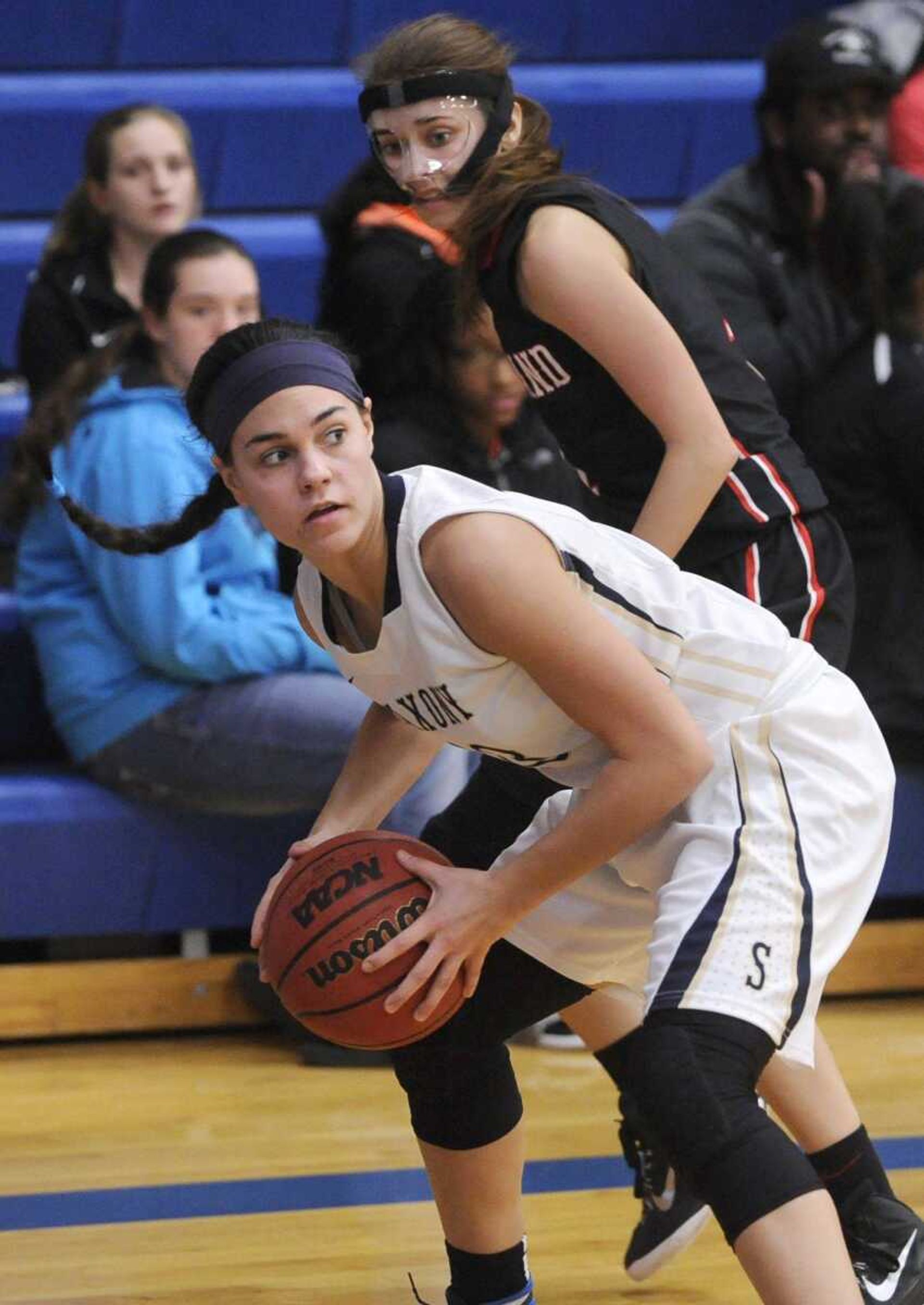 Saxony Lutheran's Ali Galemmo beats Woodland's Whitney Lincoln to the ball in the corner during the third quarter of a semifinal game in the Delta New Year's Tournament Tuesday, Jan. 5, 2016 in Delta, Missouri. (Fred Lynch)