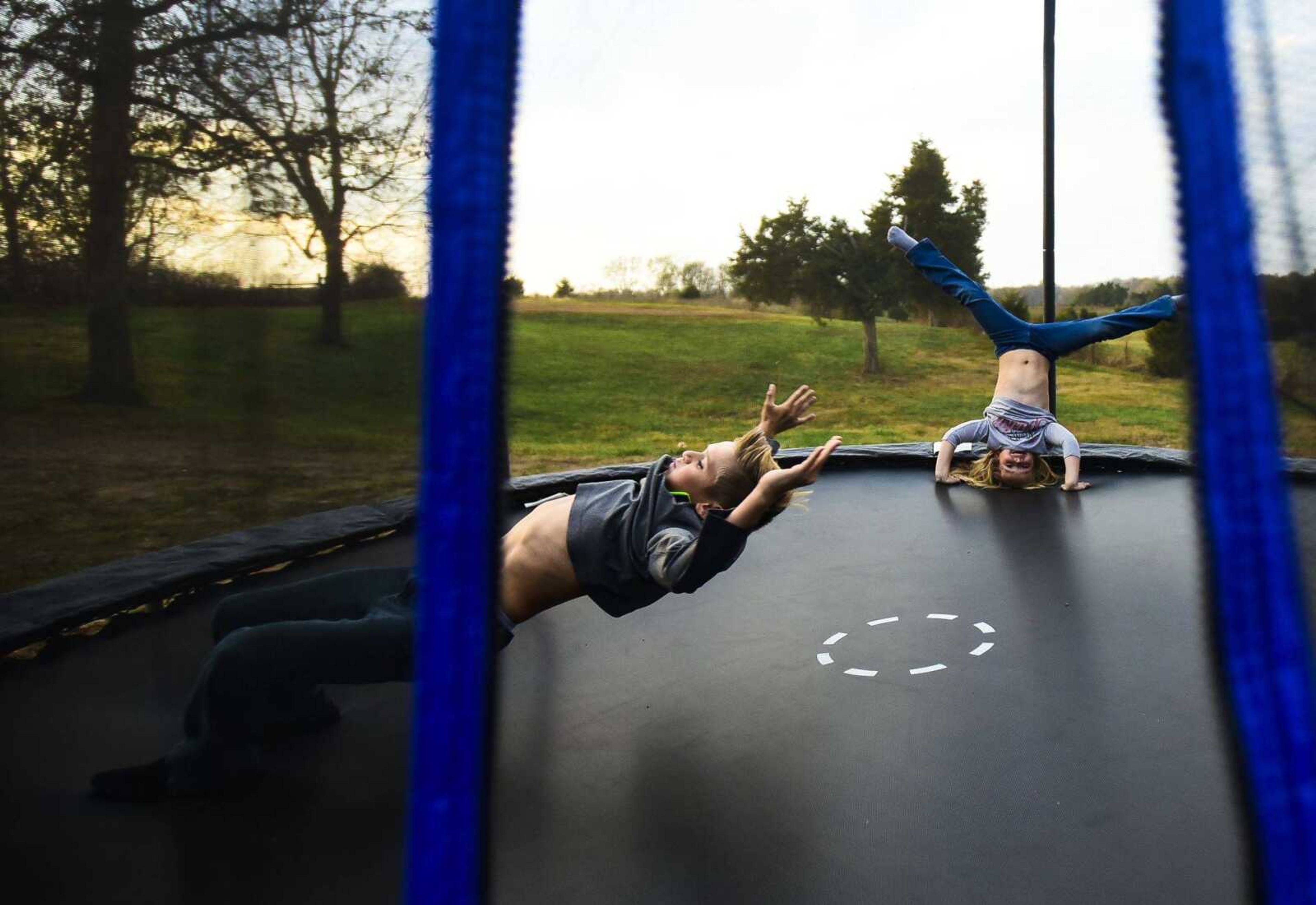 Connor Moore, 10, left, and his sister Raelyn Moore, 5, jump around on their trampoline Nov. 2 in Perryville, Missouri. About seven months ago, Connor was involved in an accident while driving with his friend on his UTV where it flipped over and pinned him into the ground. He since has made a full recovery.