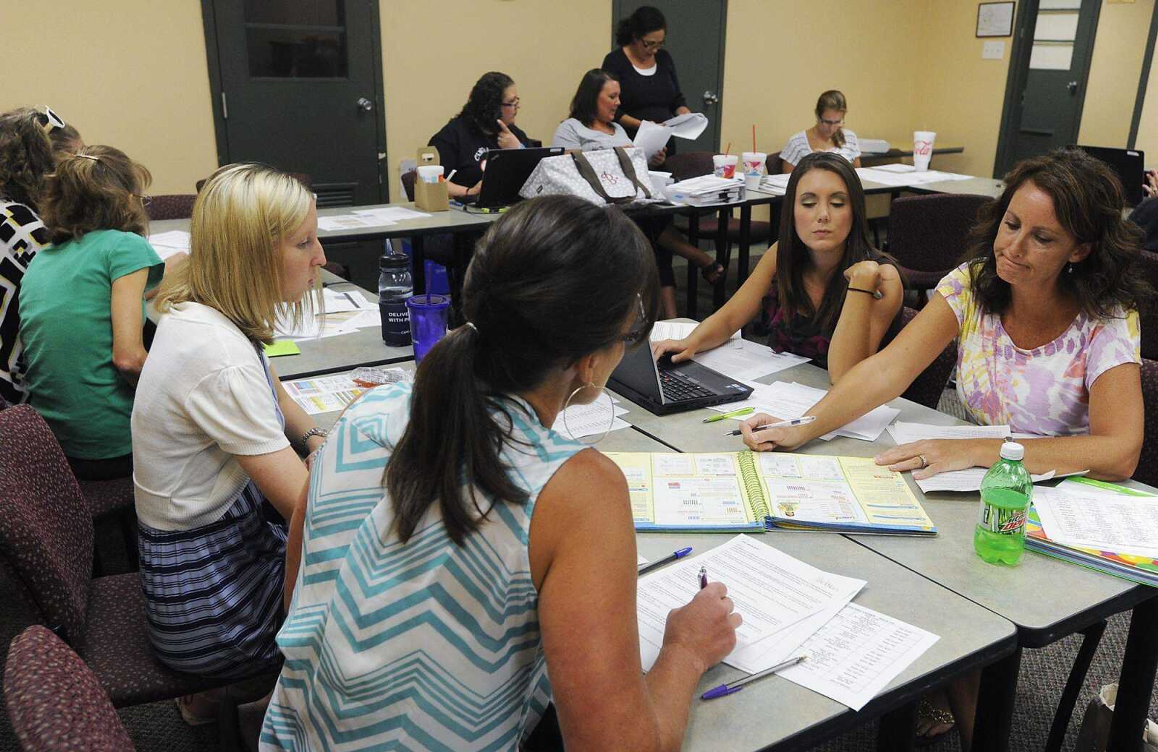 First-grade teachers Ashley Kelley, left, Jennie McCord, Whitney Carter and Gretchen Bunch discuss plans for the coming school year&#8217;s curriculum Wednesday at the Cape Girardeau School District office. Teachers are preparing to move to Common Core education standards. (Adam Vogler)