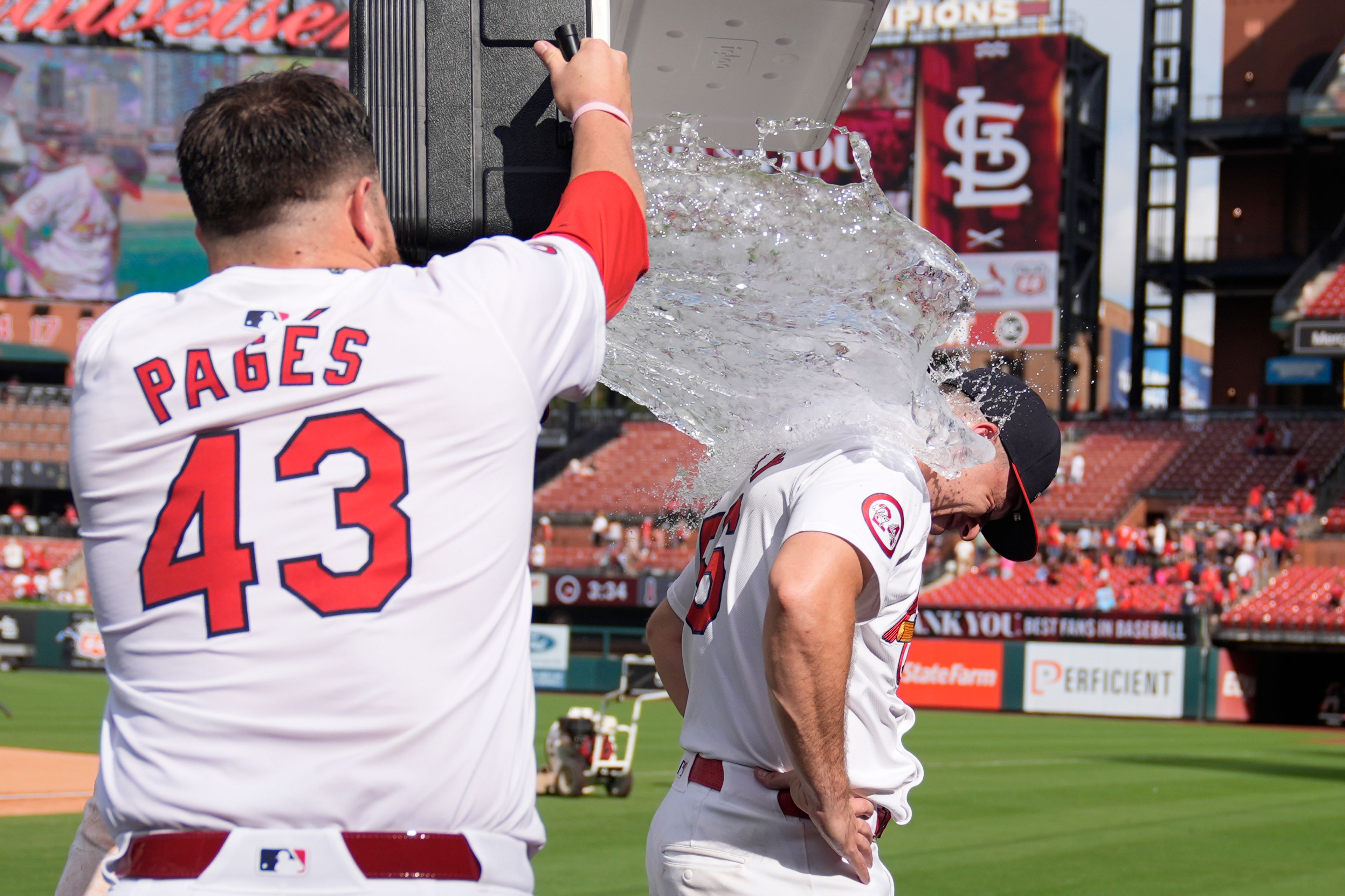 St. Louis Cardinals relief pitcher Ryan Helsley, right, is doused by teammate Pedro Pages (43) following a baseball game against the Cleveland Guardians Sunday, Sept. 22, 2024, in St. Louis. (AP Photo/Jeff Roberson)