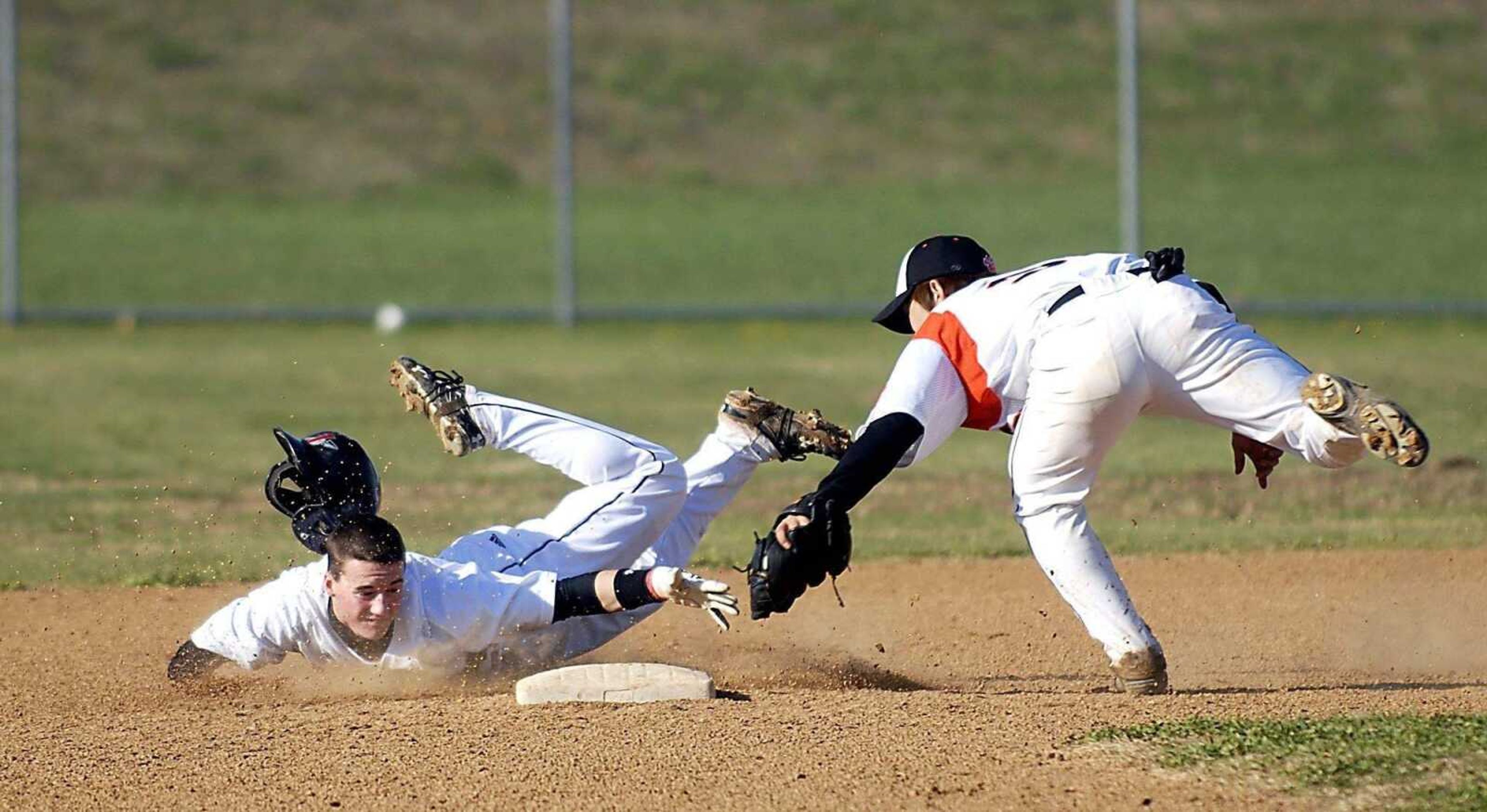 KIT DOYLE ~ kdoyle@semissourian.com<br>Jackson runner Josh Duncan slides past second base after Central second baseman Hideaki Tanaka tagged him out Tuesday afternoon at Central. Duncan tried to stretch a single into a double.