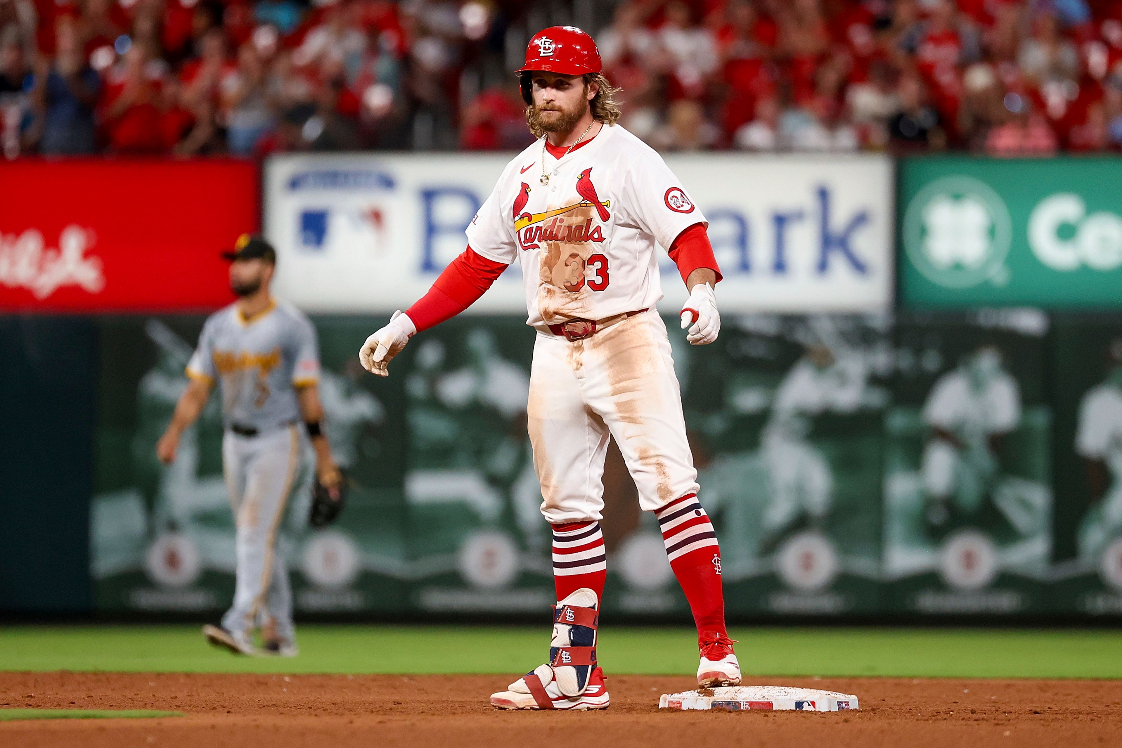 St. Louis Cardinals' Brendan Donovan, foreground, looks toward the dugout after hitting an RBI double during the sixth inning of a baseball game against the Pittsburgh Pirates, Thursday, Sept. 19, 2024, in St. Louis. (AP Photo/Scott Kane)