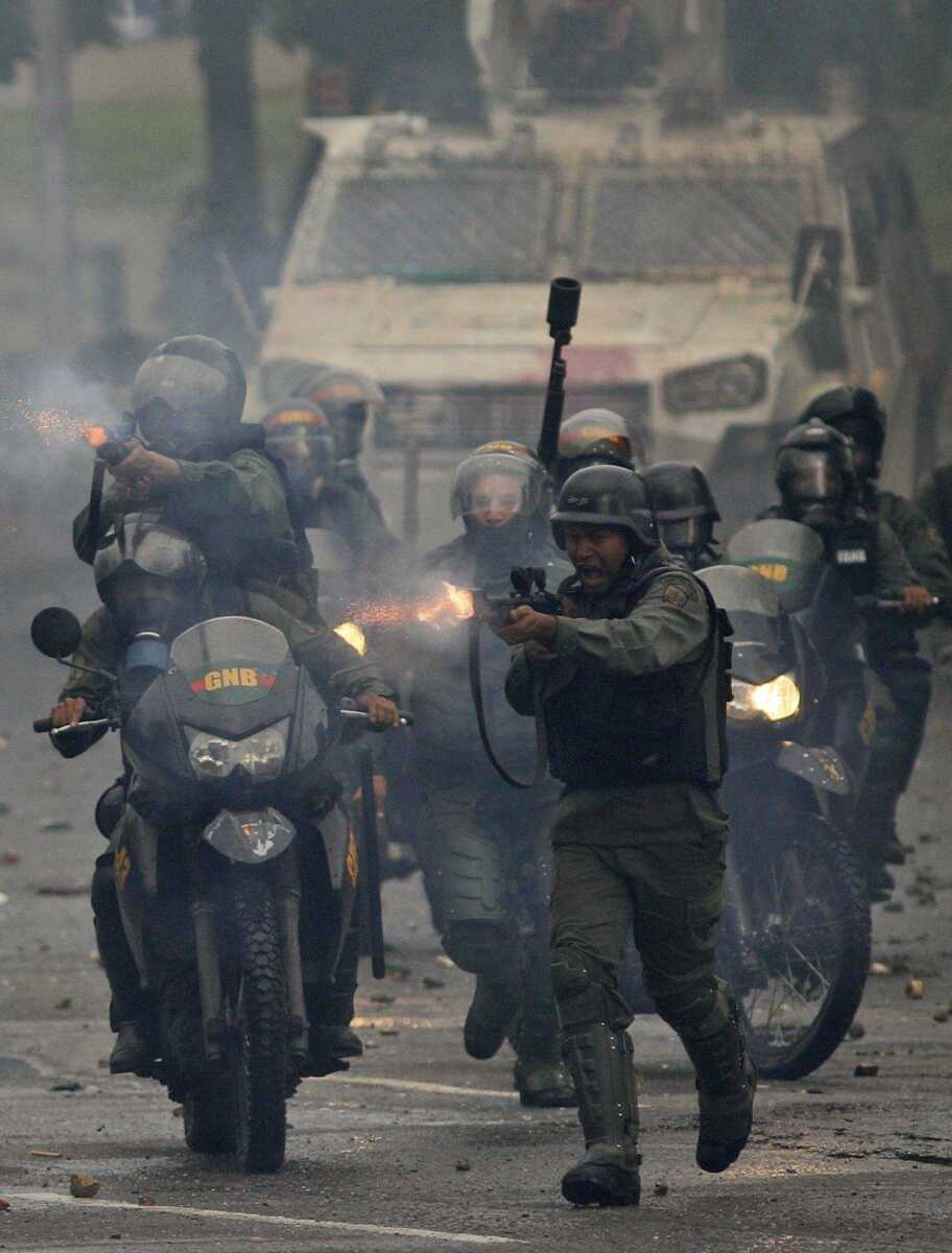 Bolivarian National Guard soldiers fire rubber bullets on anti-government demonstrators in Caracas, Venezuela.