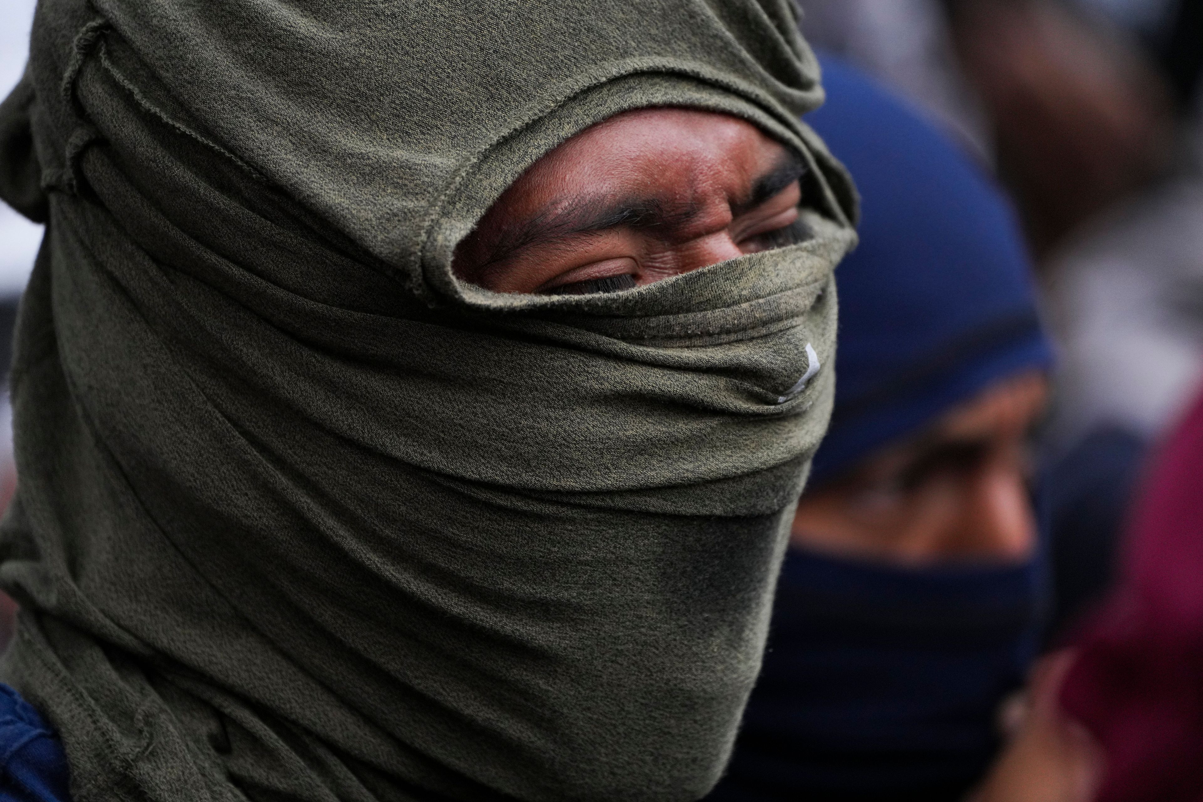 Hooded students demonstrate ahead of the 10th anniversary of the disappearance of 43 Ayotzinapa students in Guerrero state, outside of the Senate building in Mexico City, Tuesday, Sept. 24, 2024. (AP Photo/Fernando Llano)