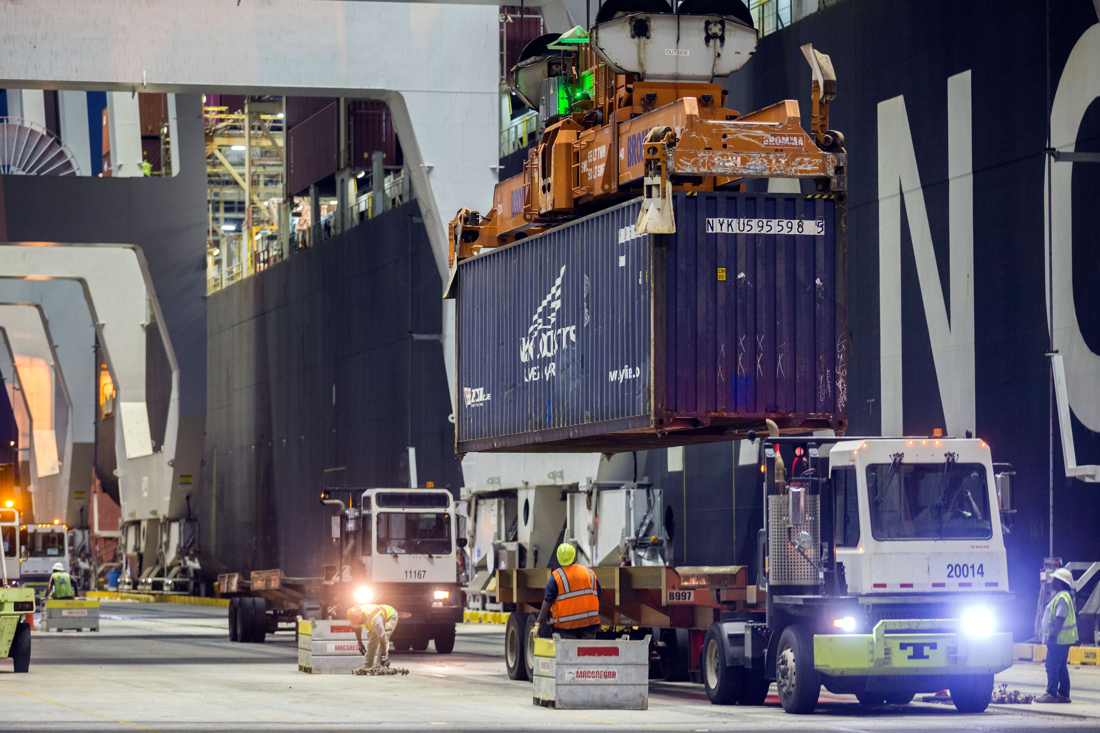 FILE - Five ship to shore cranes and gangs of longshoremen work the container ship YM Witness at the Georgia Ports Authority's Port of Savannah, Sept. 29, 2021, in Savannah, Ga. (AP Photo/Stephen B. Morton, File)