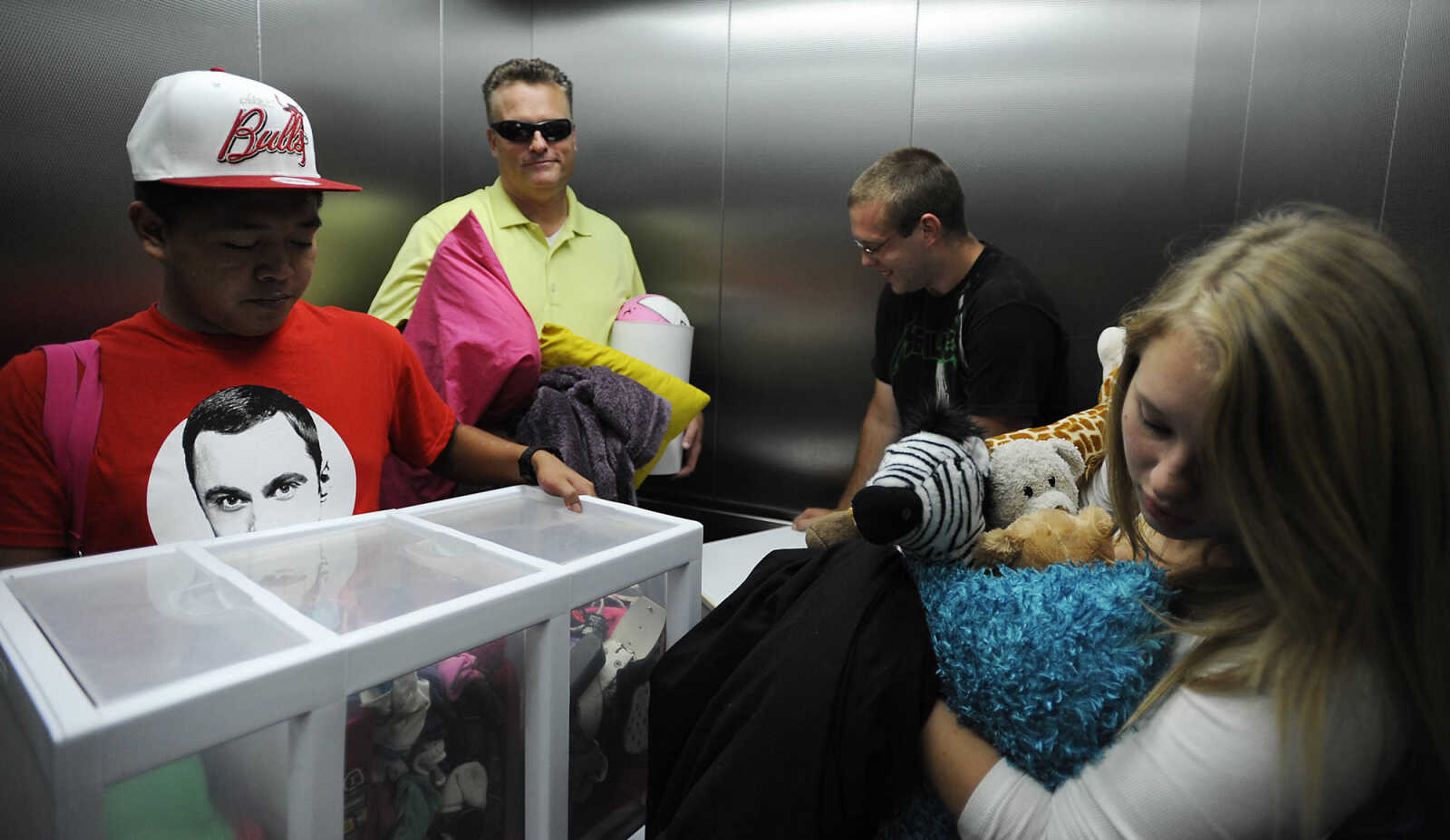 Joseph Seno, left, Jim Cribbs, Andy Cribbs and Sarah Cribbs ride the elevator in New Hall as they move Sarah's belongings into her dorm room during move in day Thursday, Aug. 22, at Southeast Missouri State University. Andy is a sophomore at SEMO while his sister Sarah entering her first semester.