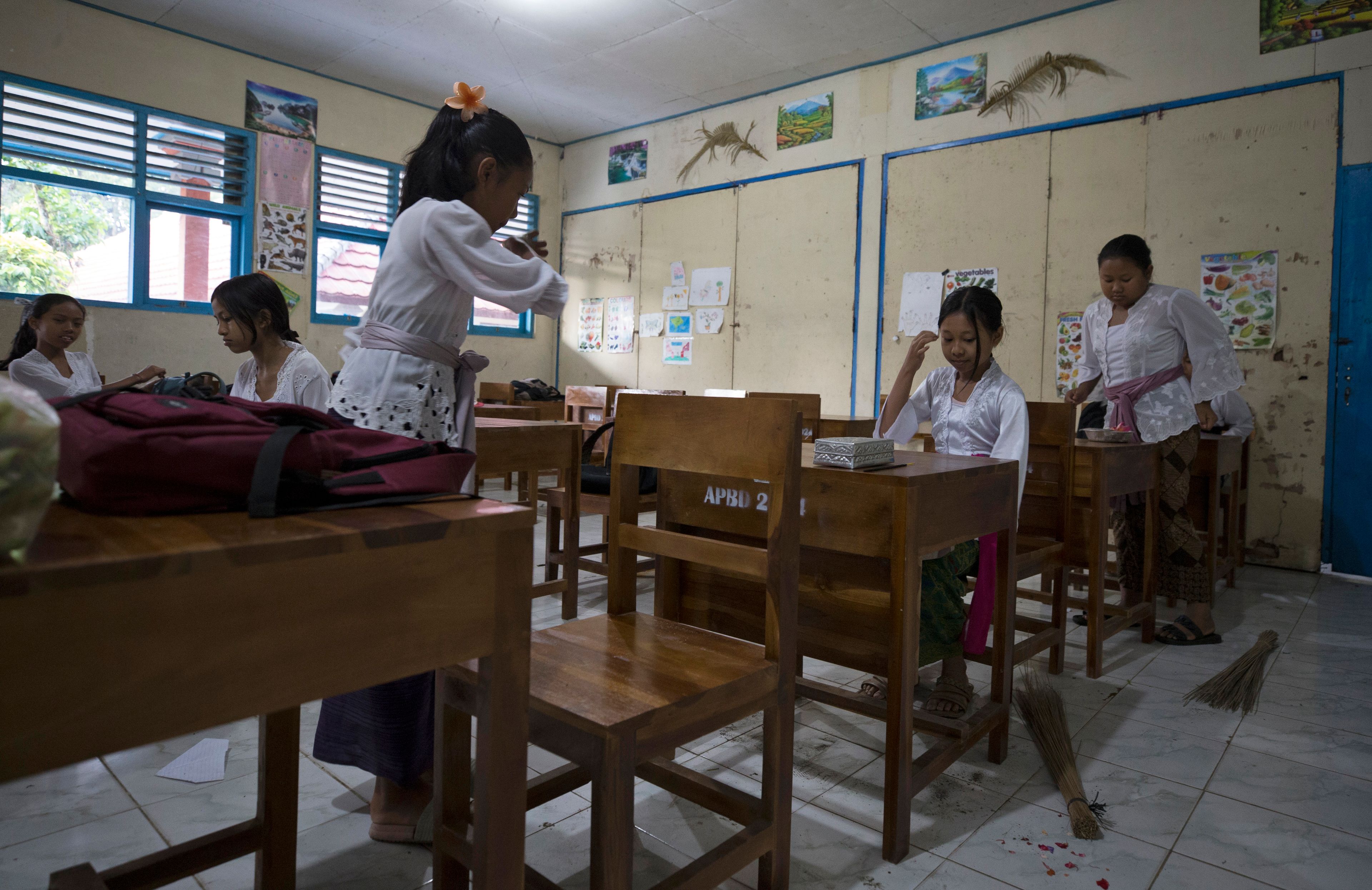 Ketut Nita Wahyuni, second right, sits in her classroom in Geriana Kauh village, Karangasem, Bali, Indonesia on Thursday, Nov. 21, 2024. (AP Photo/Firdia Lisnawati)