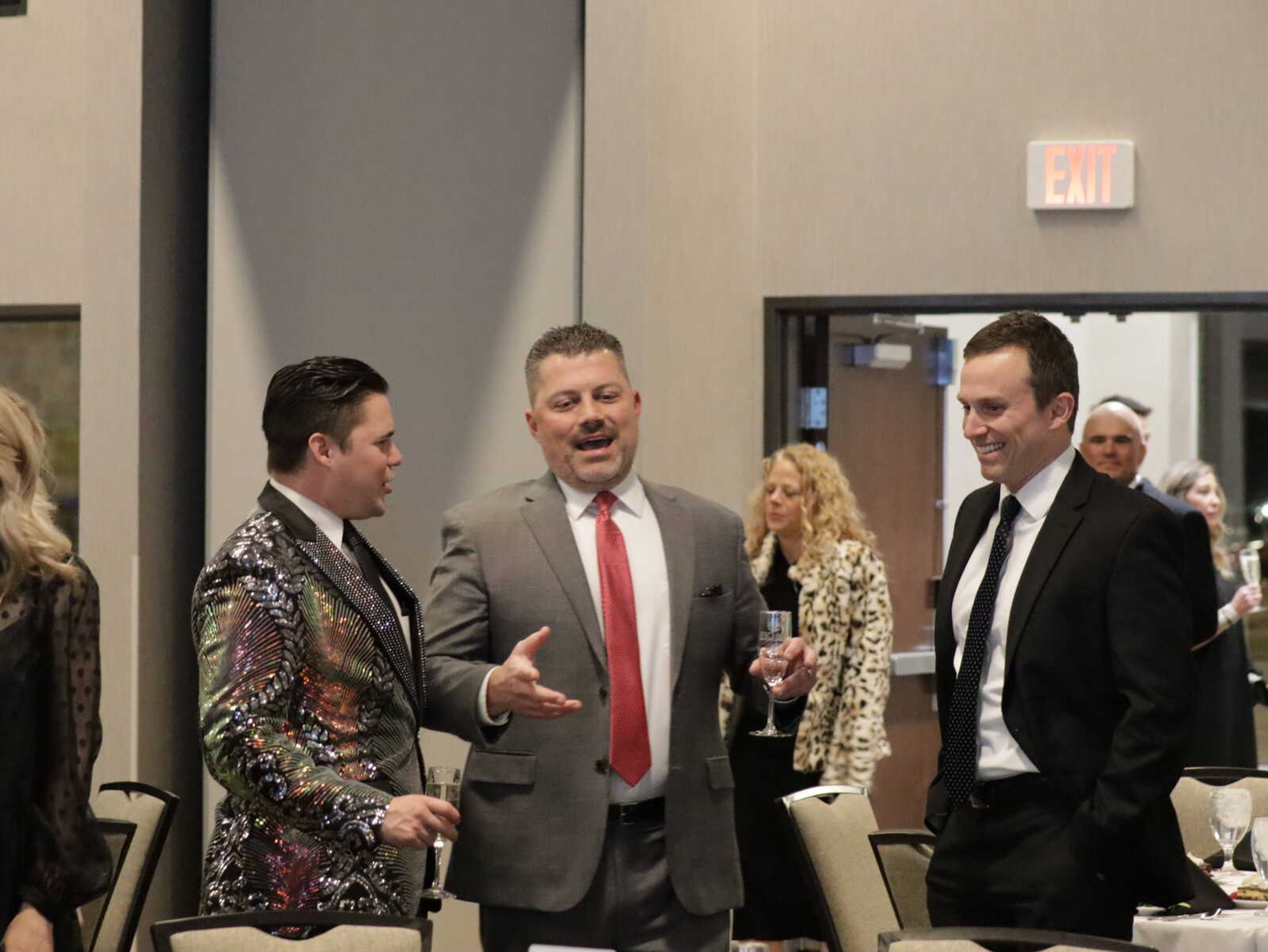 Attendees laughing together while they wait for dinner.