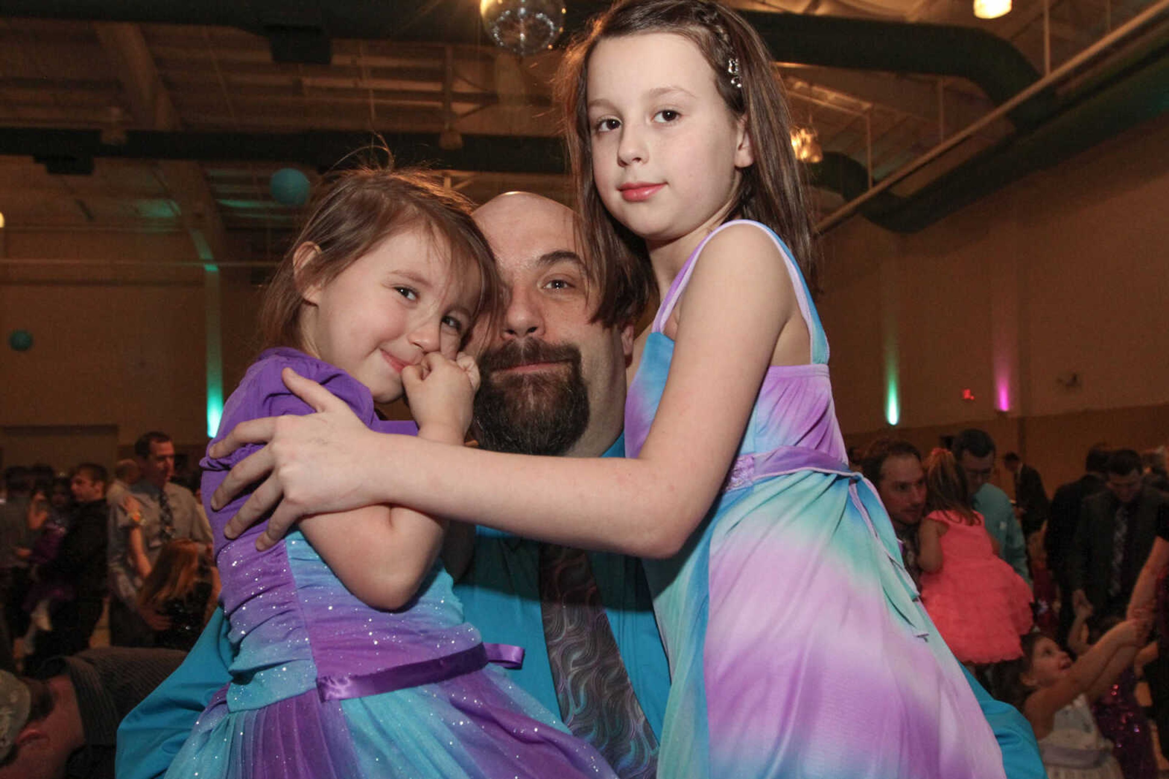 GLENN LANDBERG ~ glandberg@semissourian.com

Chris Darby dances with his daughters Savannah and Christina during the 7th annual Father/Daughter Dance Saturday, Feb. 21, 2015 at the Osage Centre.