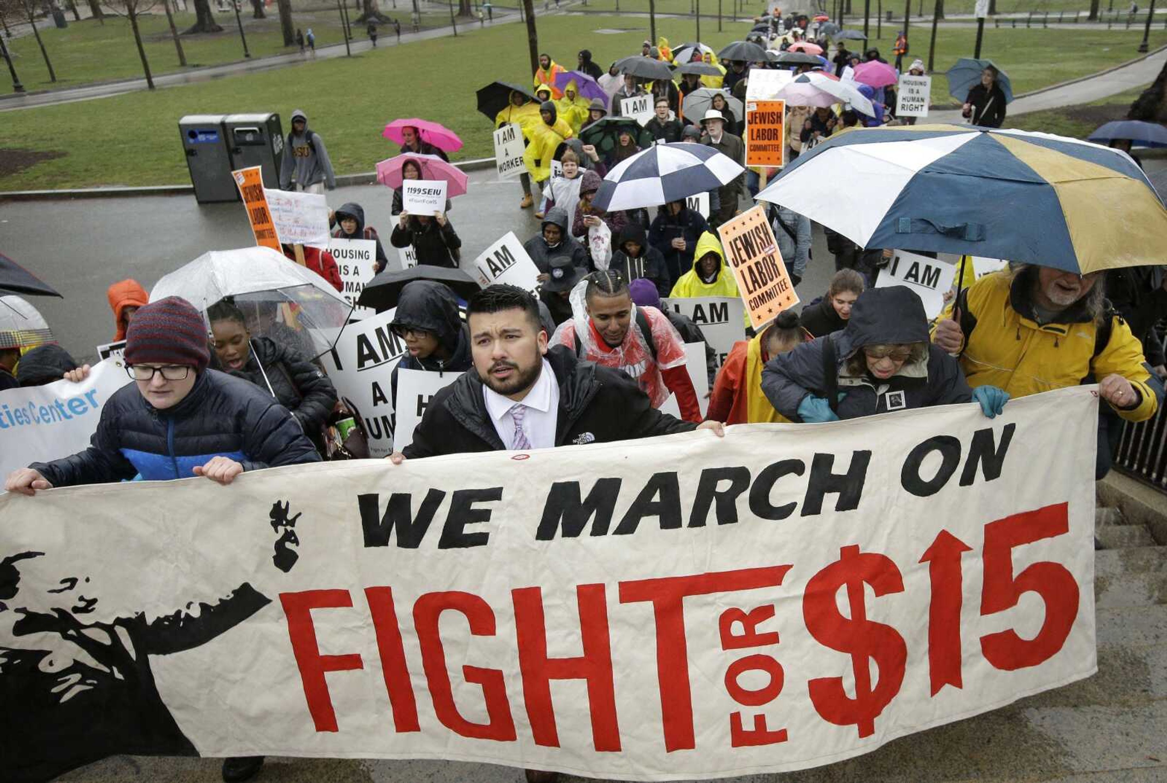 Demonstrators carry signs and shout slogans during a protest Tuesday, April 4, 2017, in Boston, held to voice their concerns about racism and call attention to low wages. Tuesday was the 49th anniversary of the assassination of civil rights leader Martin Luther King Jr. (AP Photo/Steven Senne)