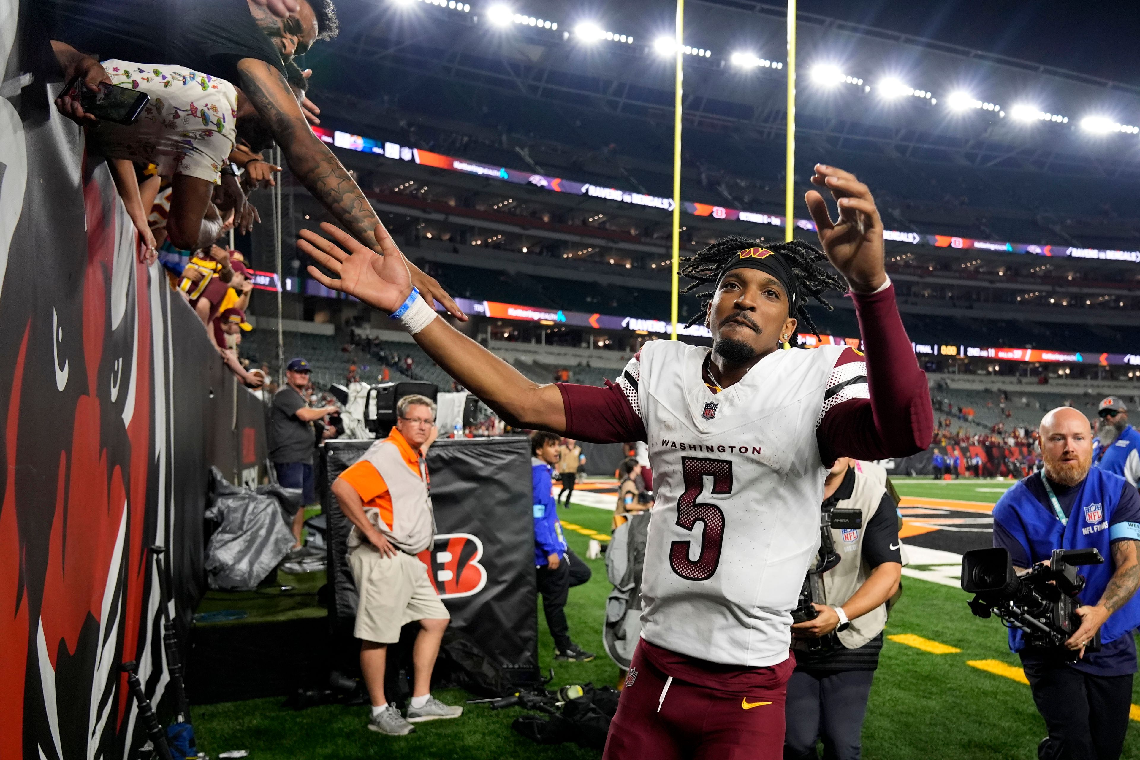 Washington Commanders quarterback Jayden Daniels (5) greets fans as he walks off the field after an NFL football game against the Cincinnati Bengals, Monday, Sept. 23, 2024, in Cincinnati. The Commanders won 38-33. (AP Photo/Carolyn Kaster)