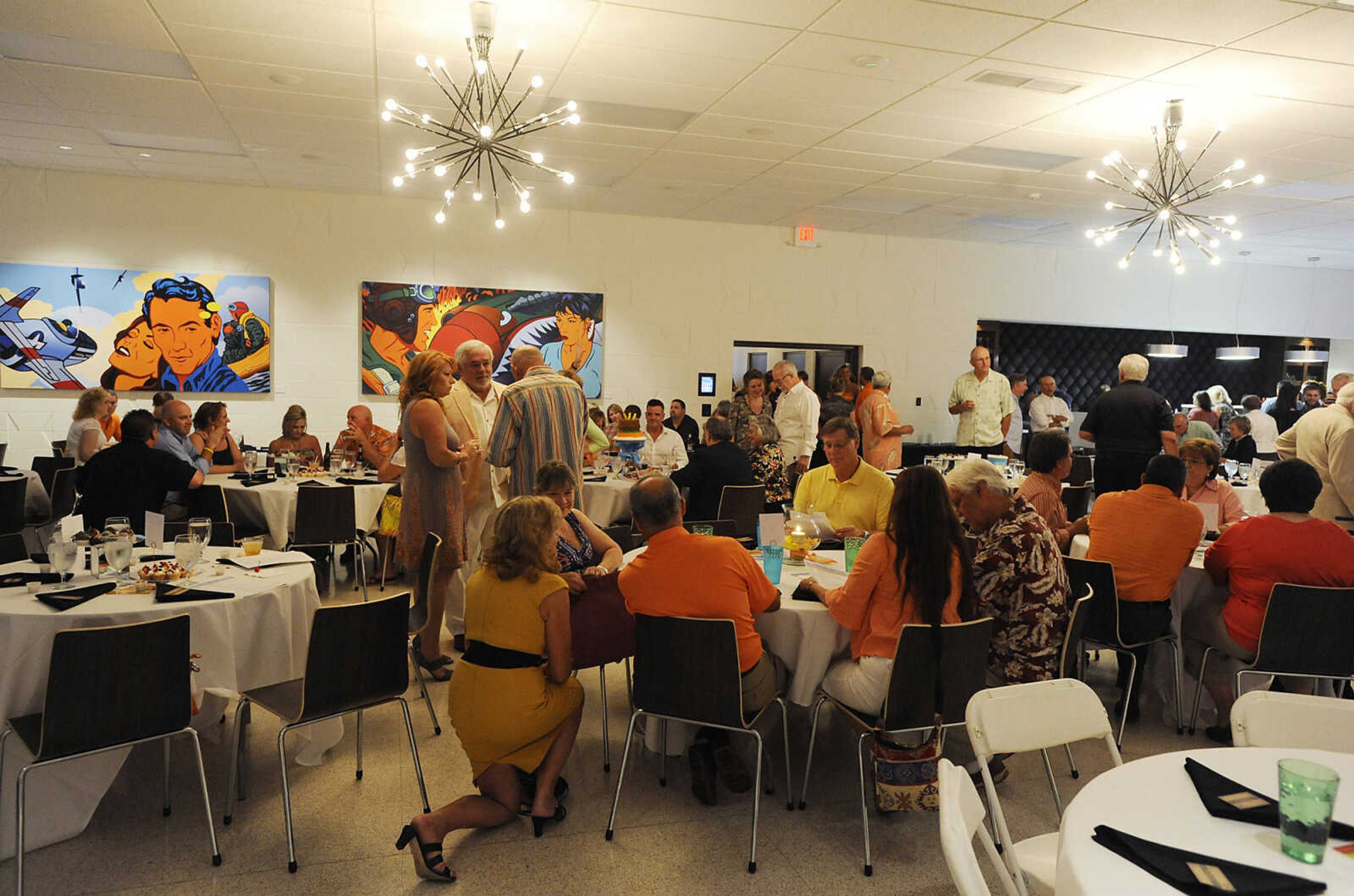 Attendees mingle during The Summer Cocktail Soiree Friday, Aug. 3, at the Concourse, 429 N. Broadview St. in Cape Girardeau. A fundraiser for Levi's Adventure Trail, an exhibit at the Discovery Playhouse in Cape Girardeau, the event featured live music, a silent auction and gourmet appetizers. The exhibit is named after Levi Stephen Collom, who died at age 3 earlier this year.