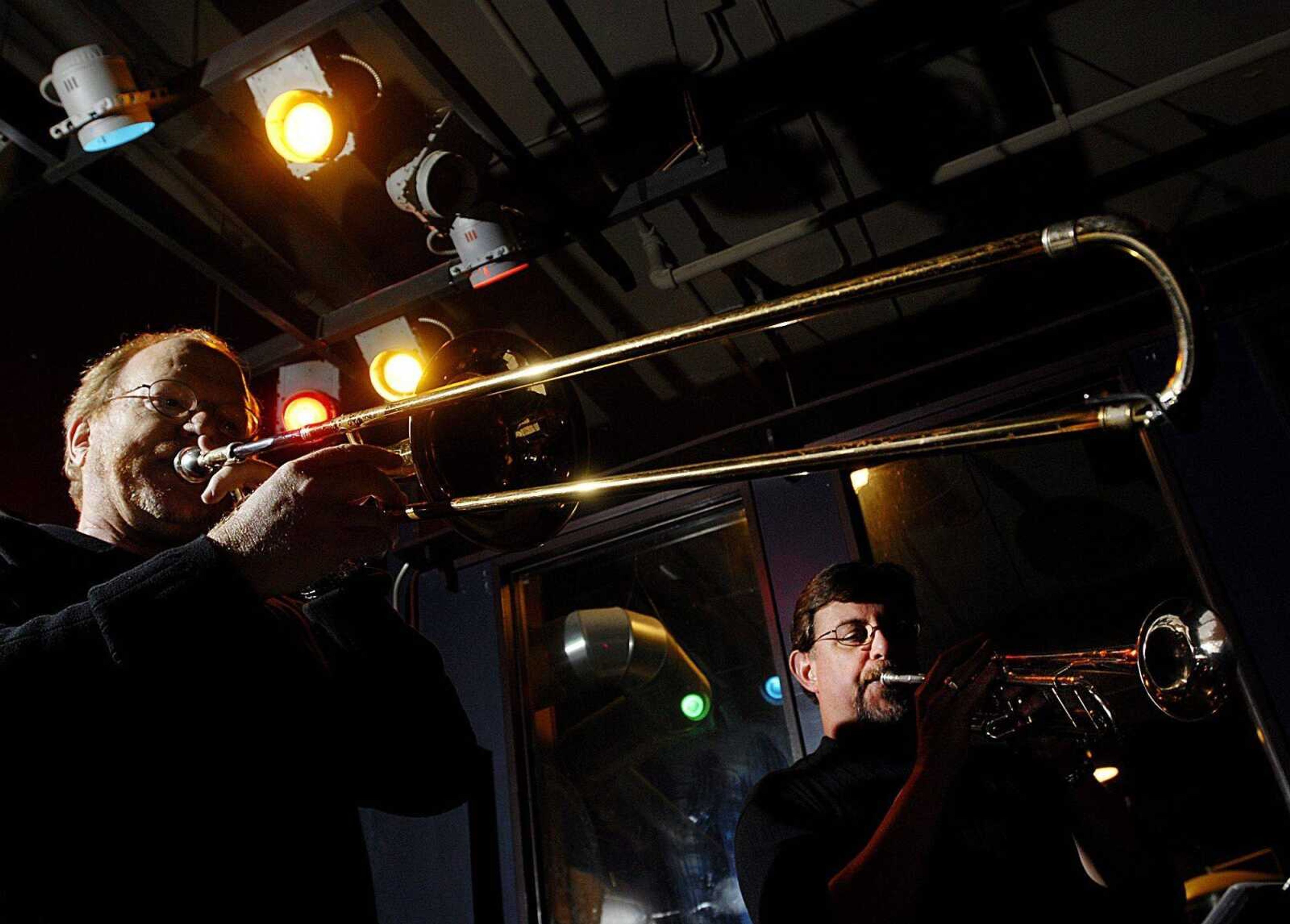 Robert Conger plays the trombone while Barry Bernhardt plays trumpet during a performance by the Sultans of Swing on Friday, December 6, 2007 at Buckner's. (Aaron Eisenhauer)