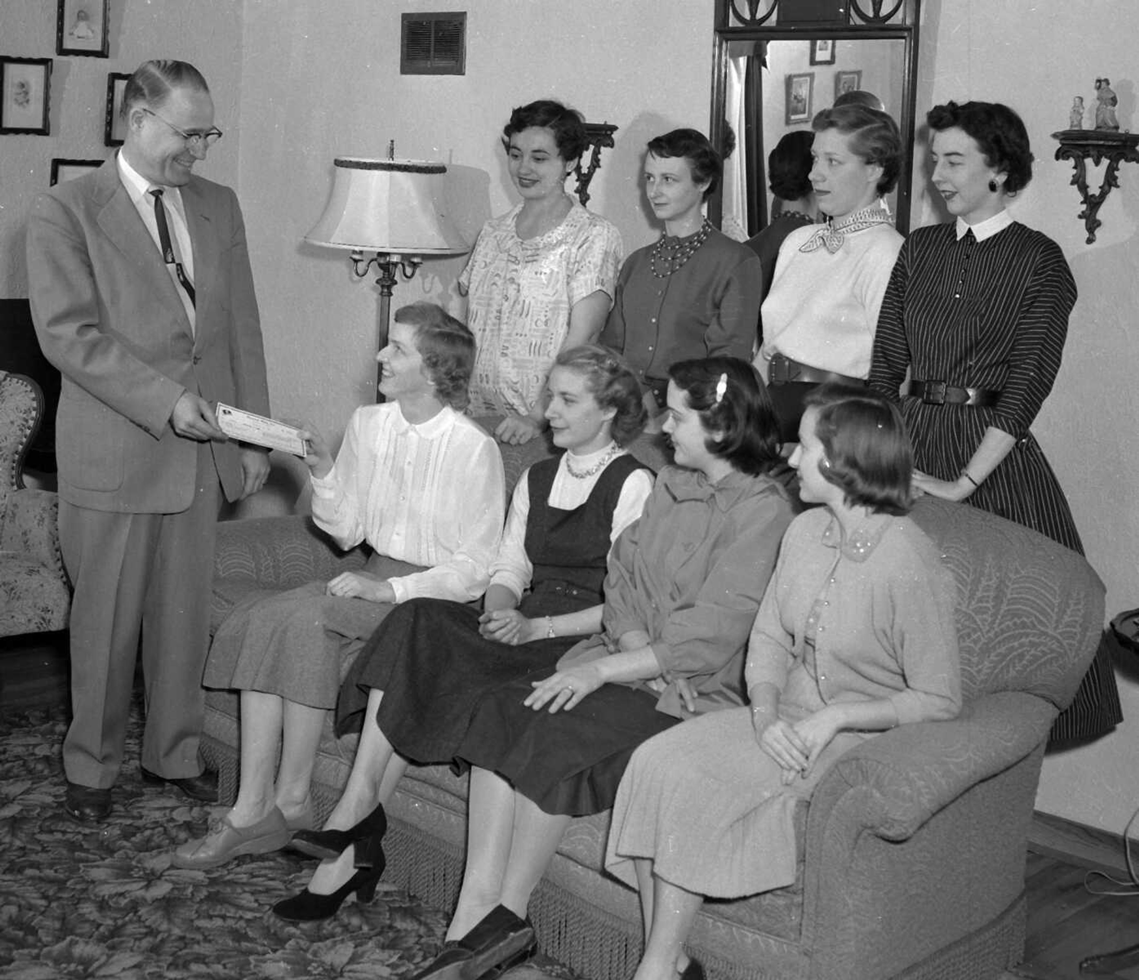 Dec. 16, 1954 Southeast Missourian.
The Jayceettes had earned $378.30 for selling Betty Crocker cake mix, and James M. Hughey of Piedmont, district representative for General Mills, Inc., presents check to Mrs. Lawrence Bahn Jr. From the left, seated, are Mrs. James Lansmon, Mrs. Robert Hirsch and Mrs. Robert G. Brady. Standing: Mrs. Charles Knote, Mrs. George Farrar, Mrs. Robert Oliphant and Mrs. Don Barklage. The money will go for hospital aid and United Fund. (G.D. Fronabarger/Southeast Missourian archive)