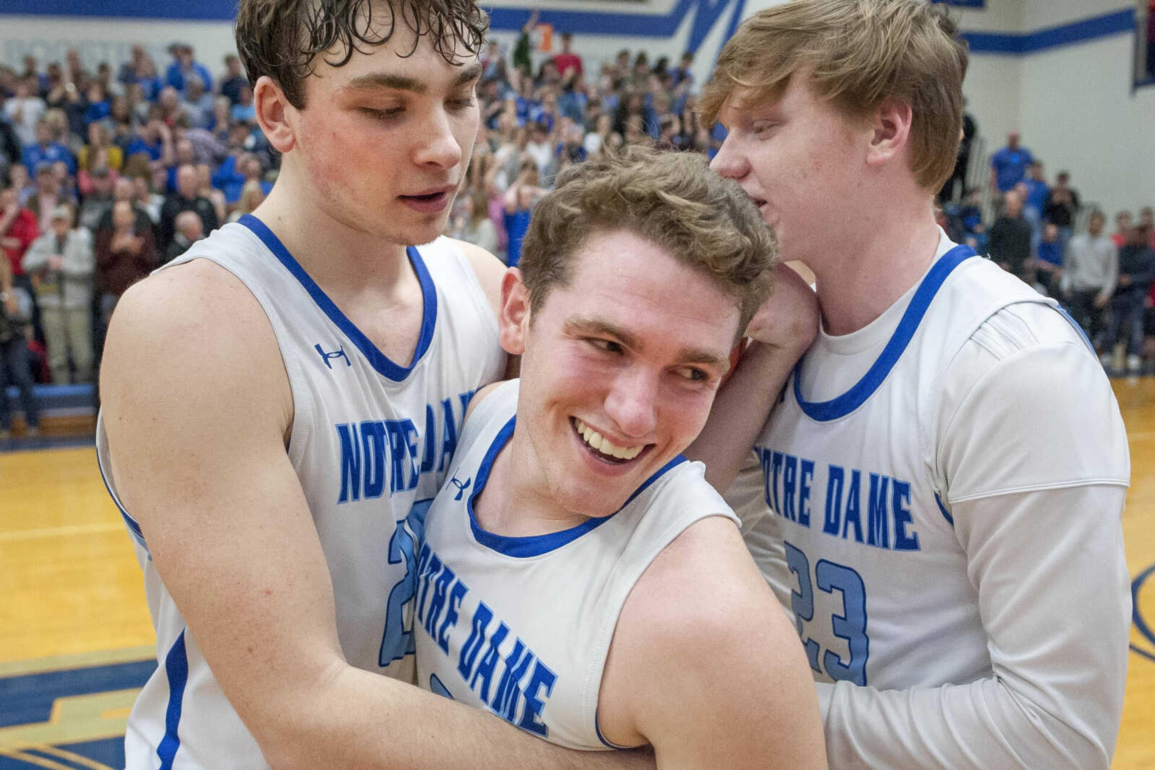 Notre Dame's Tyler Landewee smiles while being hugged by teammate Justice Thoma, left, after beating Dexter Tuesday, March 3, 2020, at Notre Dame Regional High School in Cape Girardeau.