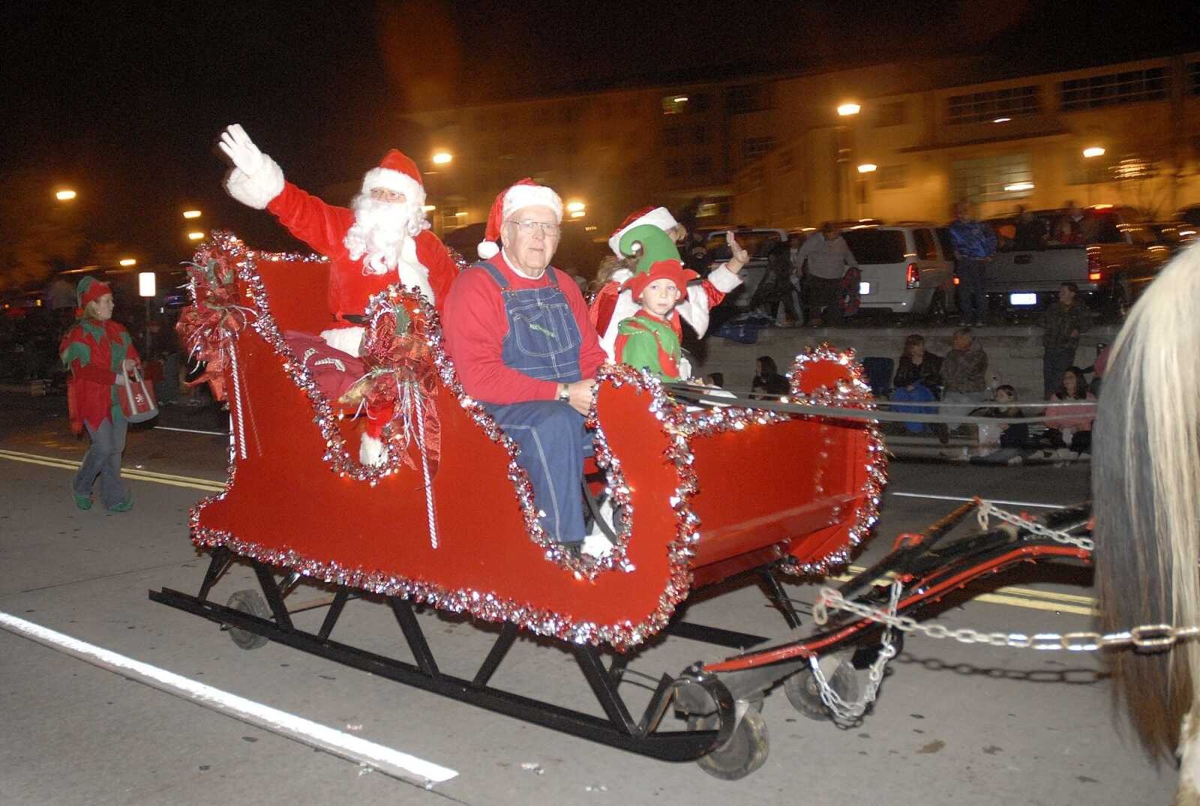 Santa and his helpers ride down Broadway in Cape Girardeau during the Parade of Lights. (Laura Simon)