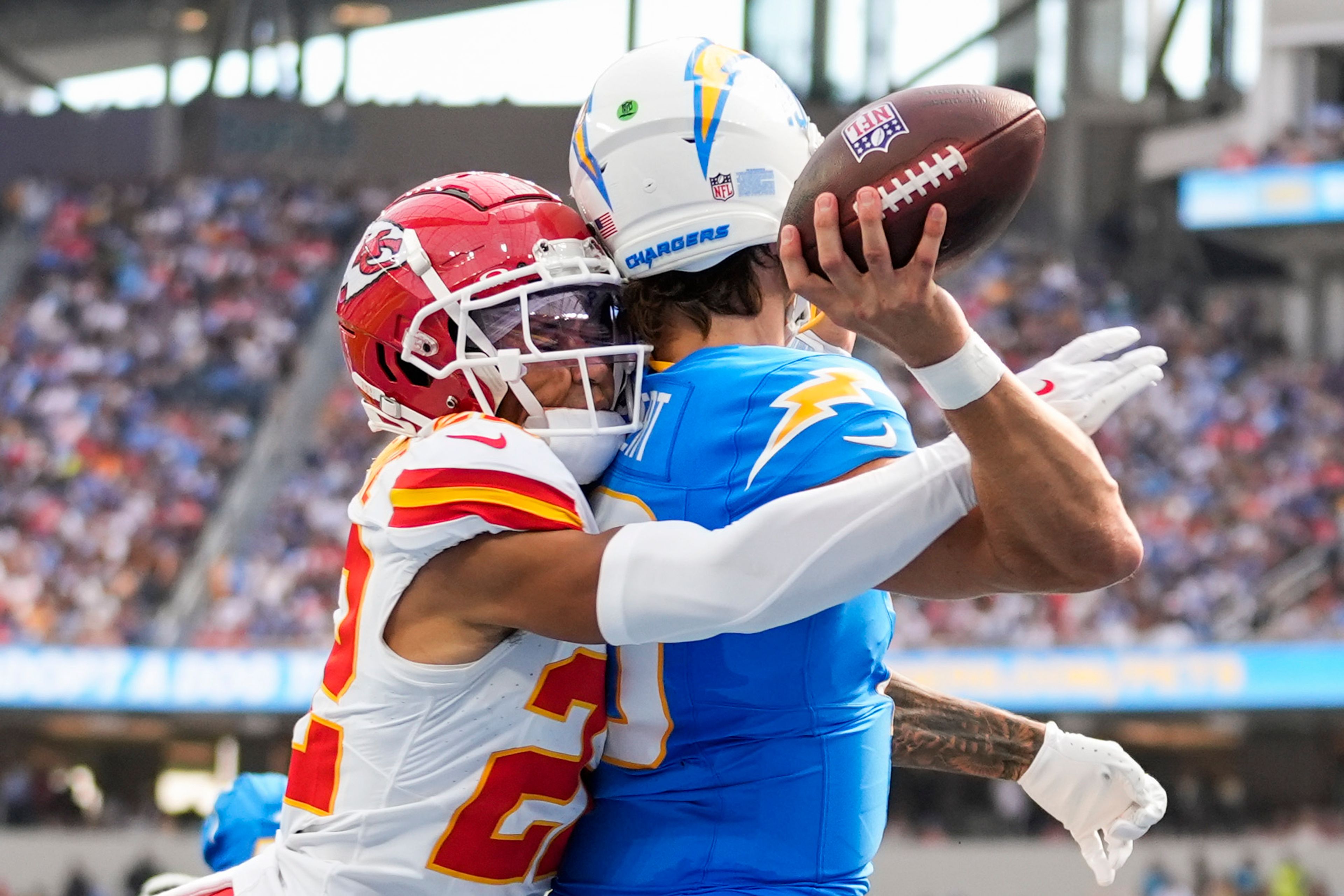 Los Angeles Chargers quarterback Justin Herbert throws under pressure from Kansas City Chiefs cornerback Trent McDuffie (22) during the first half of an NFL football game Sunday, Sept. 29, 2024, in Inglewood, Calif. (AP Photo/Ashley Landis)