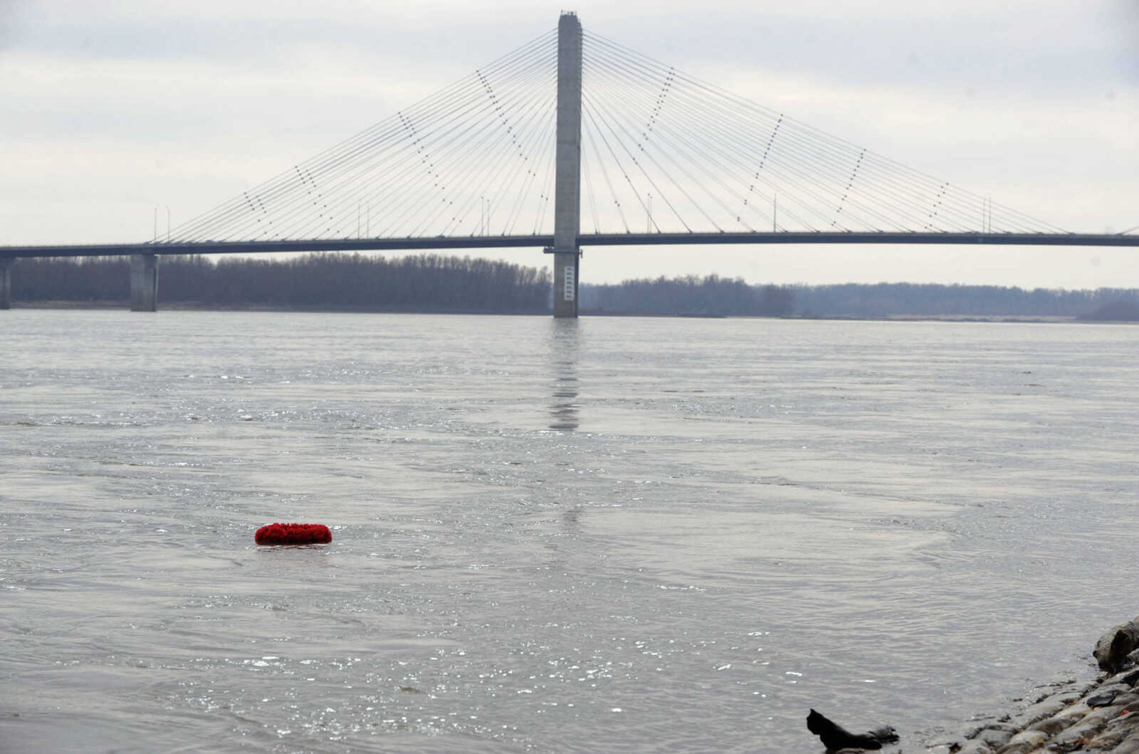 The wreath floats down the Mississippi River after the annual American Legion Post 63 Pearl Harbor observance Sunday, Dec. 7, 2014 in Cape Girardeau.