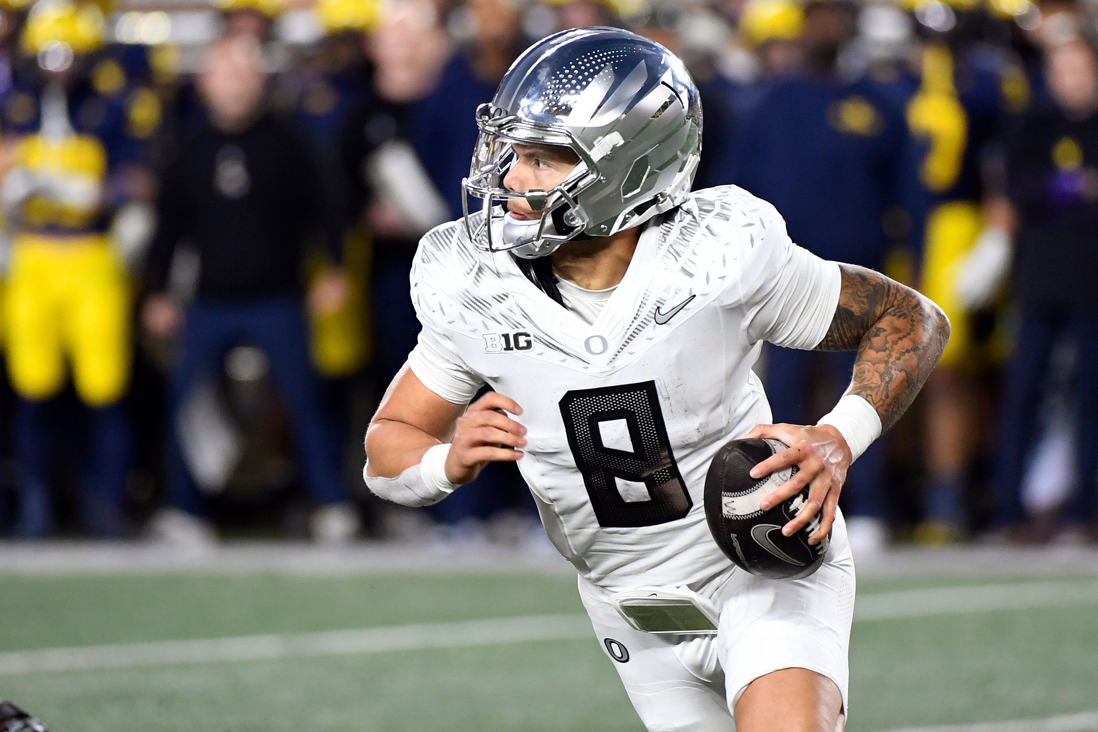 Oregon quarterback Dillon Gabriel scrambles out of the pocket against Michigan in the second half of an NCAA college football game, Saturday, Nov. 2, 2024, in Ann Arbor, Mich. Oregon defeated Michigan 38-17. (AP Photo/Jose Juarez)