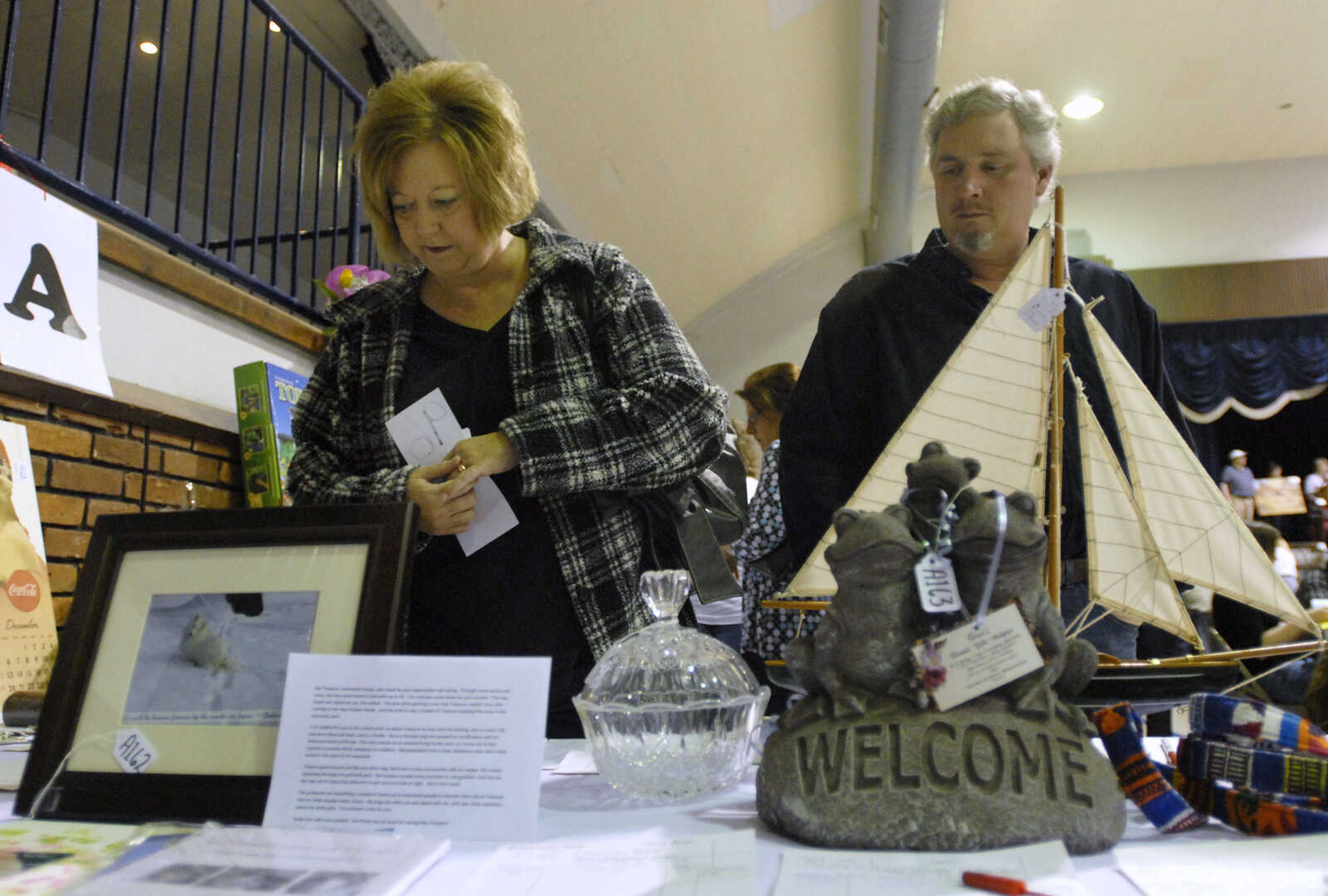 KRISTIN EBERTS ~ keberts@semissourian.com

Dwana and Danny Leible look at the silent auction items during the Humane Society of Southeast Missouri's 30th annual Dinner and Auction titled "Tales of Tails" on March 26, 2011, at the A.C. Brase Arena in Cape Girardeau. The event included dinner, awards, raffles and silent and oral auctions with proceeds benefitting the Humane Society.