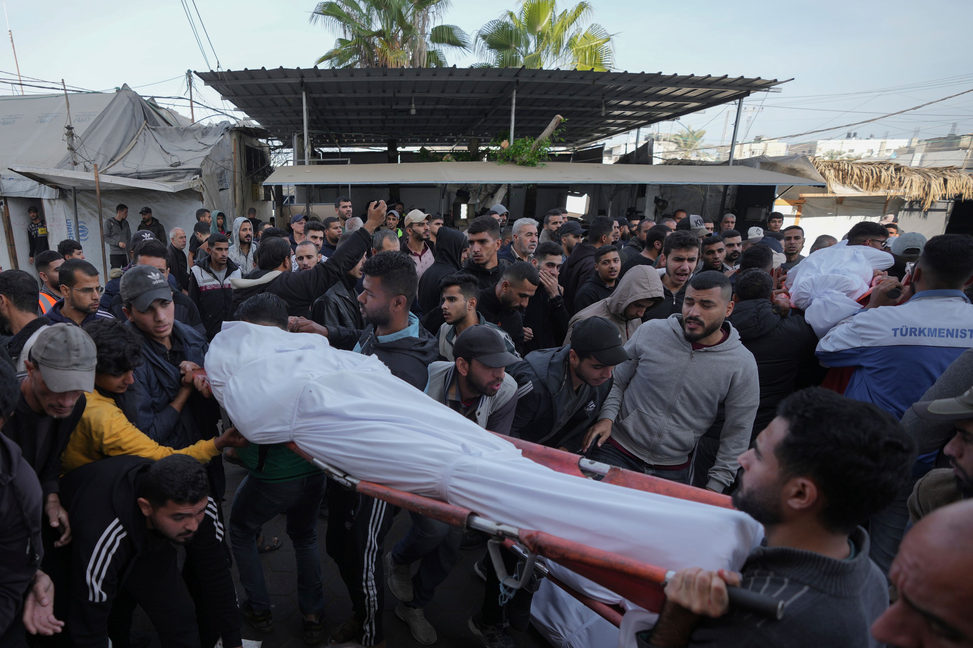 Mourners carry their relatives who were killed in the Israeli bombardment of Maghazi in the Gaza Strip, during their funeral in Deir al-Balah, Gaza, Thursday, Nov. 14, 2024. (AP Photo/Abdel Kareem Hana)