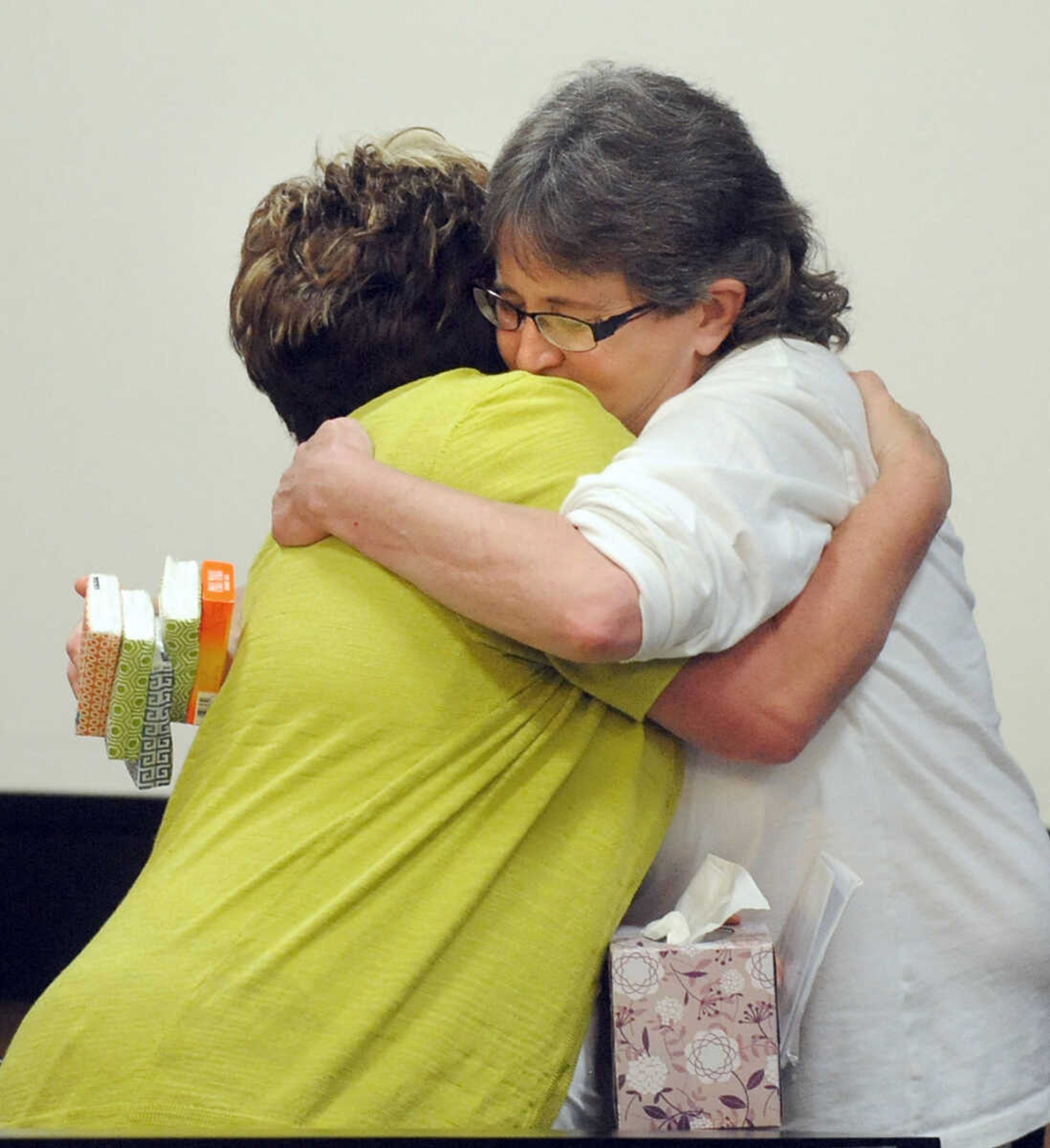 LAURA SIMON ~ lsimon@semissourian.com 
Cheryl Brenneke, left, embraces Wendi Bird Barnhart inside the courtroom, Thursday, June 6, 2013, at the Cape Girardeau County Courthouse. Clay Waller pleaded guilty to second-degree murder for the death of Brenneke's sister, Jacque Waller. Jacque Waller went missing June 1, 2011. Her body was found last Wednesday in Southern Illinois.