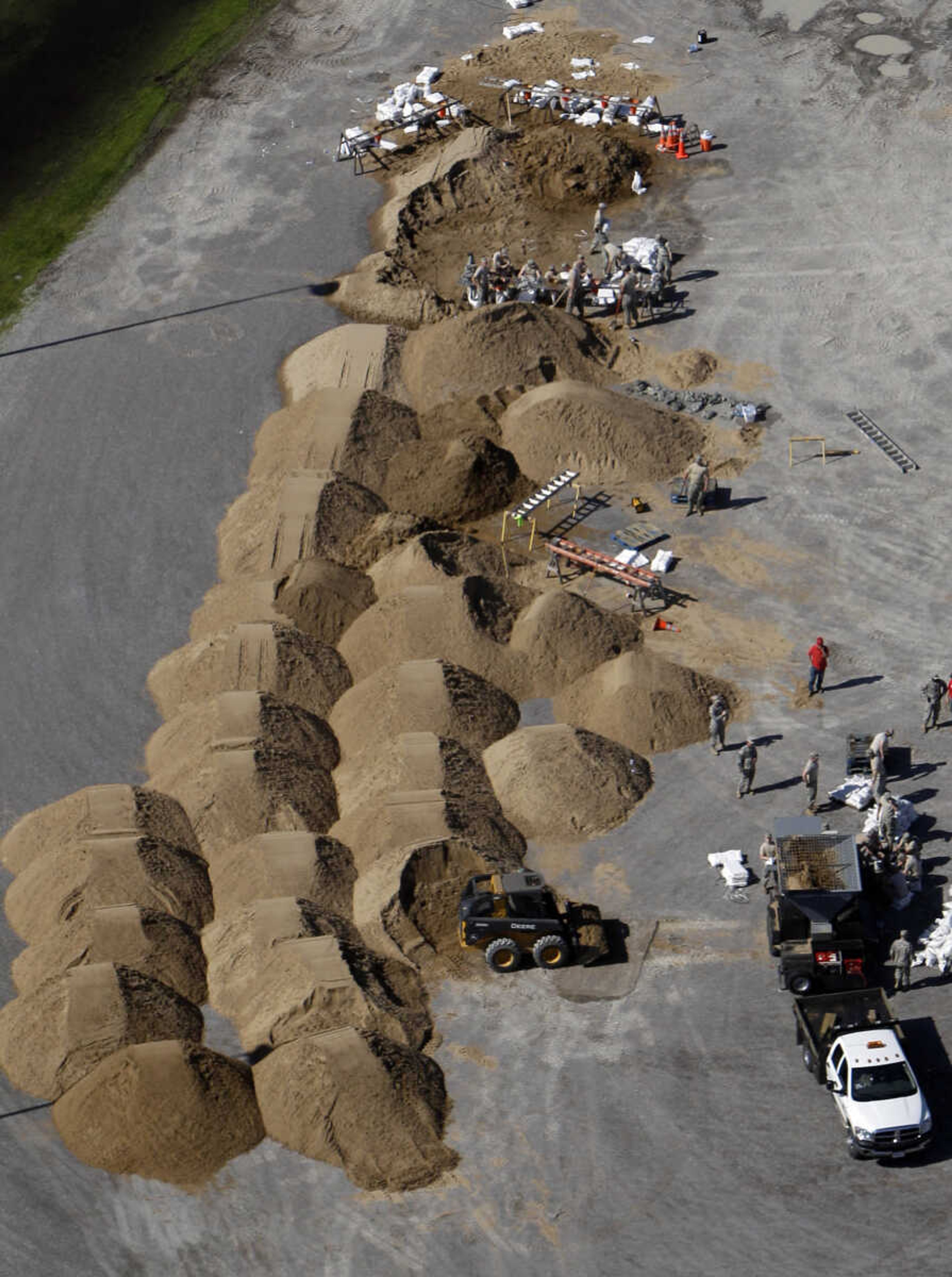 In this aerial photo made Tuesday, May 3, 2011, workers fill sandbags in Caruthersville, Mo. Officials are hoping a new sandbag secondary levee catches any spillover if the Mississippi River tops the town's 50-foot floodwall. The forecast calls for a crest of 49.5 feet on Sunday afternoon in the town still recovering from a tornado six years ago that damaged more than 500 homes and businesses. (AP Photo/Jeff Roberson)