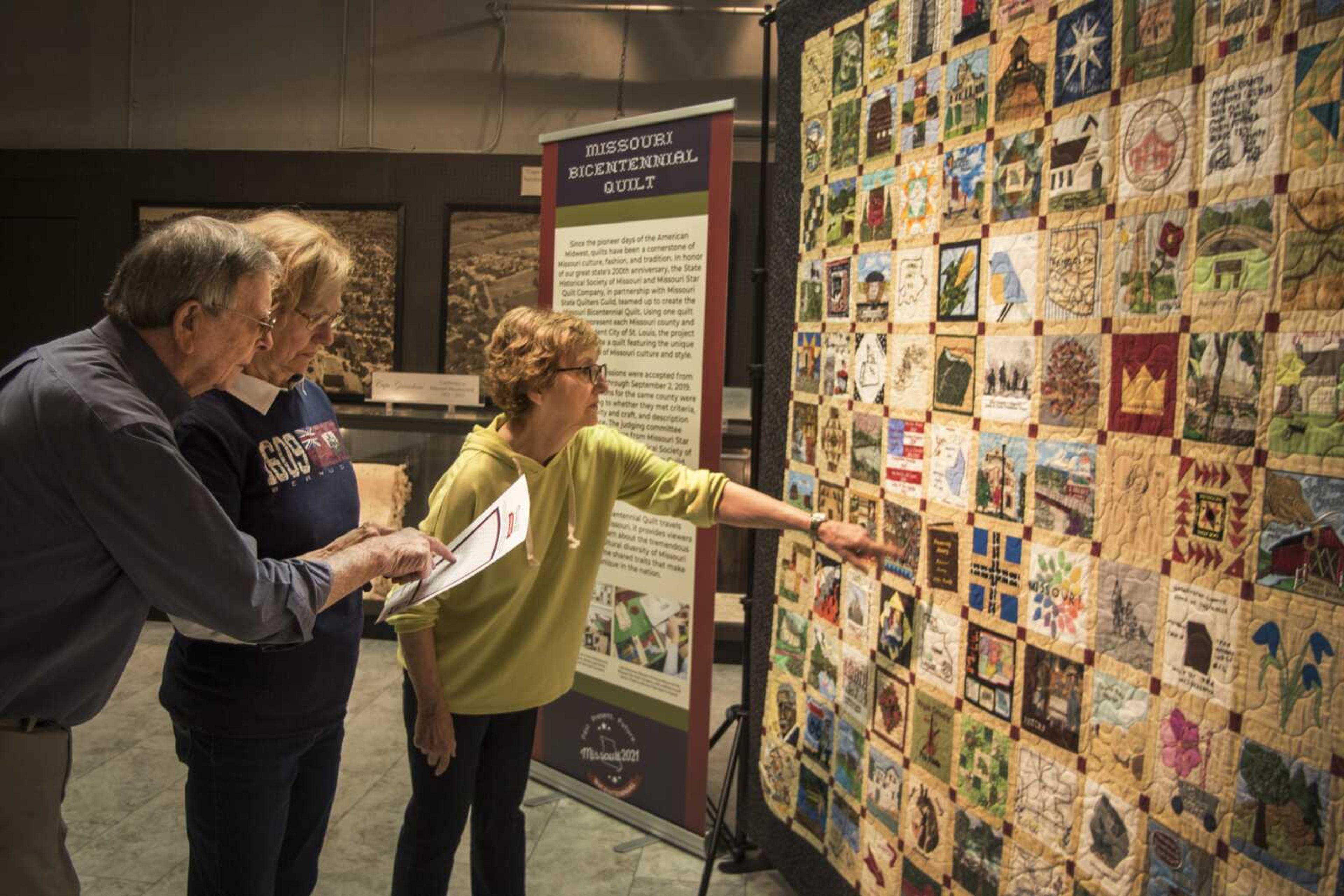 Bill Slinkard, left, Charlotte Slinkard, middle, and Maragaret Ford, right,  study the Missouri Bicentennial Quilt. Each of the quilt's 121 blocks represent a different part of Missouri or a totem of the state's culture. Quilters from around Missouri helped make the Bicentennial Quilt now hanging in the Cape River Heritage Museum in Cape Girardeau. Visitors may see the quilt starting at 5 p.m. Friday at a reception.