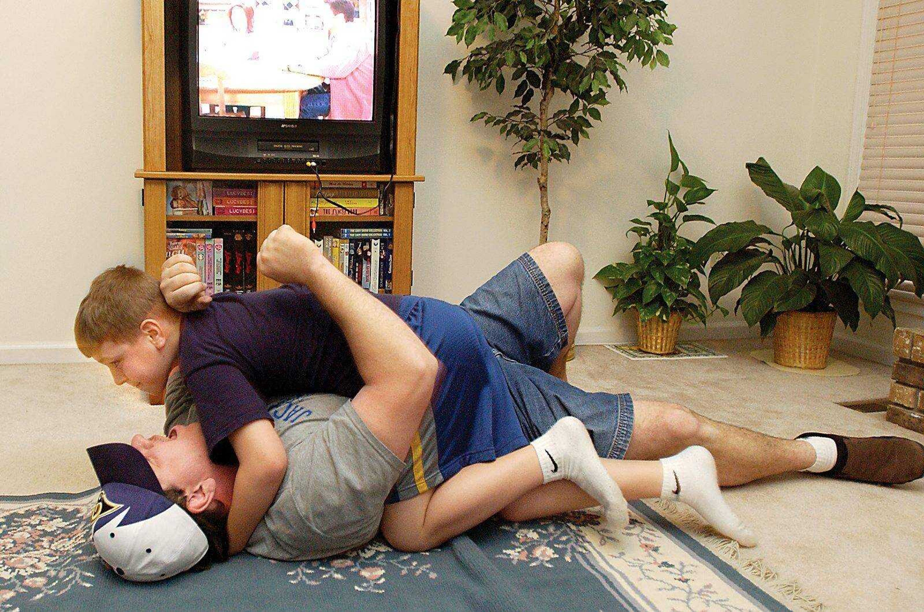 THEN: Ben Rushin, 10, wrestles with Richard Rushin at their Jackson home in 2004. (DON FRAZIER)