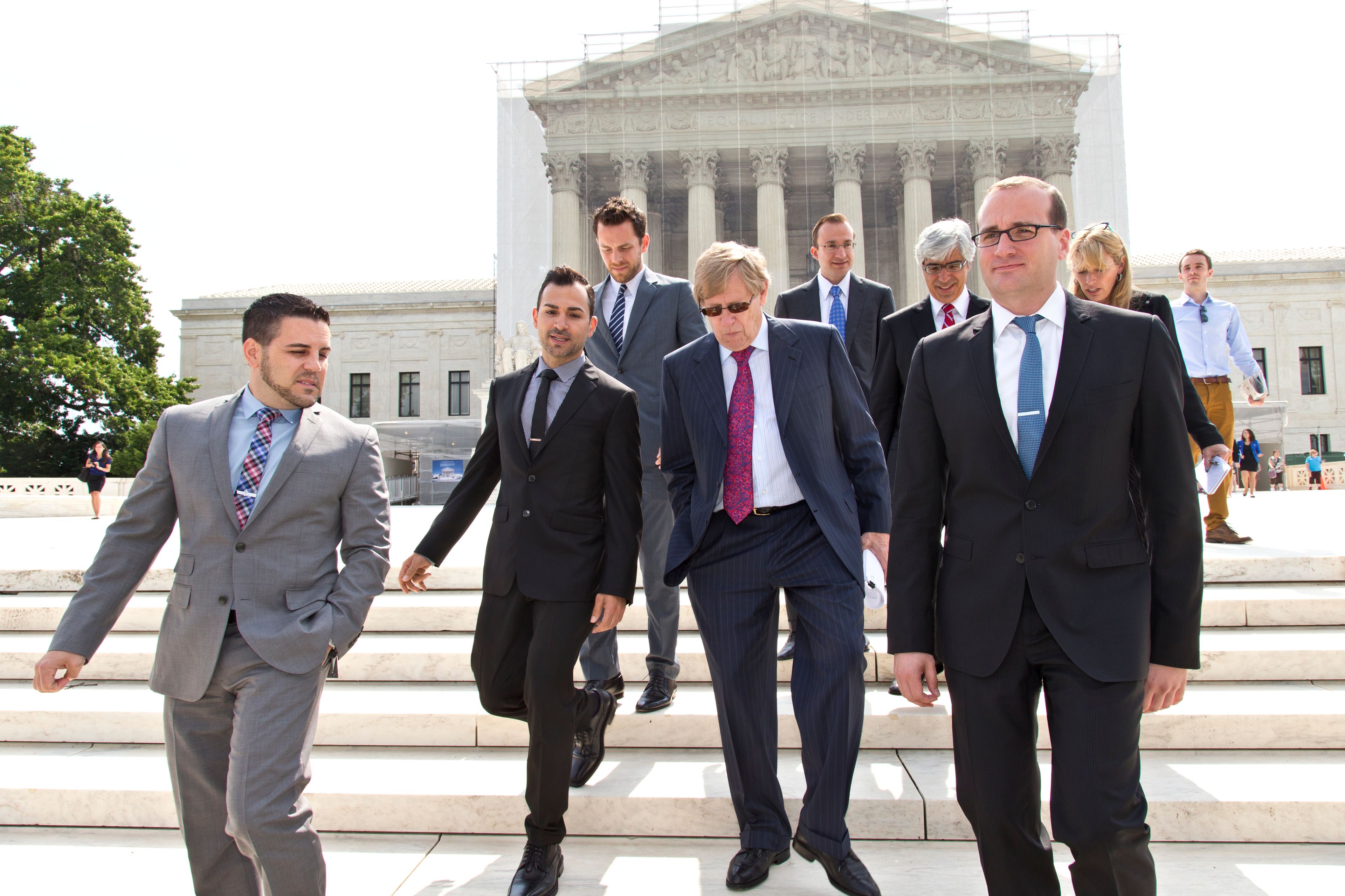 FILE - Chad Griffin, right, president of the Human Rights Campaign, leaves the Supreme Court, with Jeff Zarrillo, left, and Paul Katami, second from left, the plaintiffs in the California Proposition 8 case, and their attorney Ted Olson, center, in Washington, June 20, 2013. (AP Photo/J. Scott Applewhite, File)