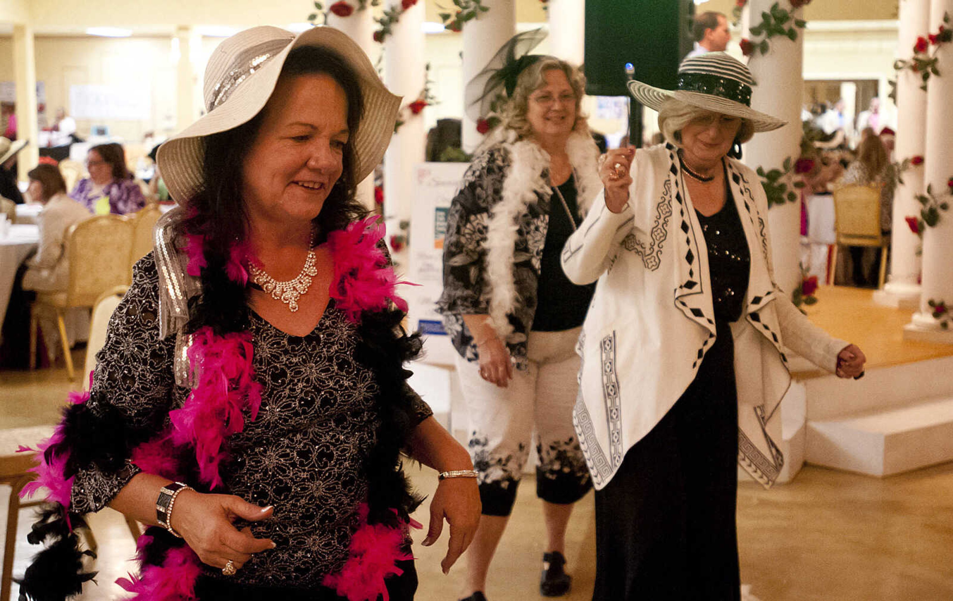 Denise Tanner, left, Linda Reinwald and Rita Weidner dance "The Electric Slide," during the Lutheran Family and Children's Services Foundation's "Boas & Bling, Kentucky Derby Party," Thursday, May 1, at The Venue in Cape Girardeau. More than 450 people attended the annual event  which is a fundraiser for the not-for-profit social services organization which provides counseling, adoption services, child care, youth mentoring services and advocacy on behalf of children and families.