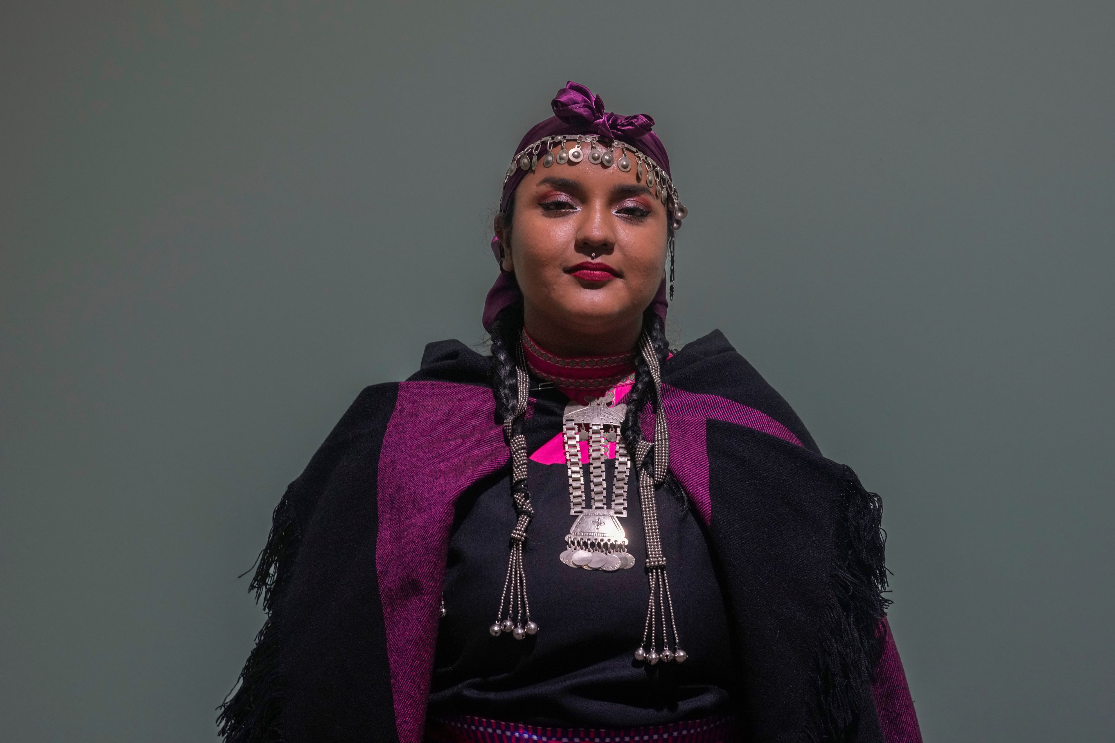 Antumalen Ayelen Antillanca Urrutia, 26, of Huapi Island, Chile, from the Mapuche Huilliche community, poses for a photo during the COP29 U.N. Climate Summit Tuesday, Nov. 12, 2024. in Baku, Azerbaijan. (AP Photo/Rafiq Maqbool)