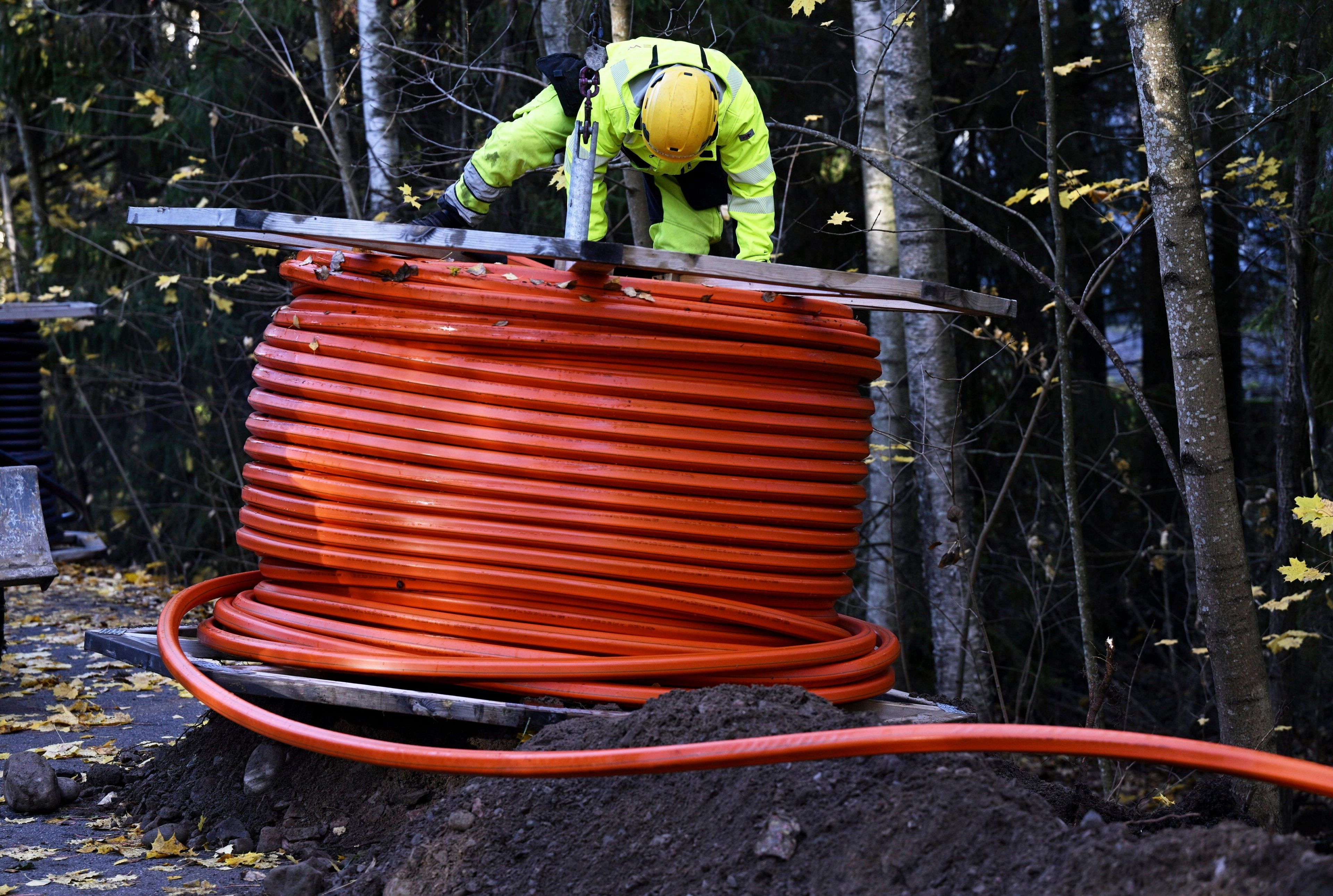 FILE - An optical fibre cable of the Swedish digital infrastructure provider GlobalConnect is being laid underground in Espoo, Finland, Wednesday, Oct. 16, 2024. (Vesa Moilanen/Lehtikuva via AP, File)