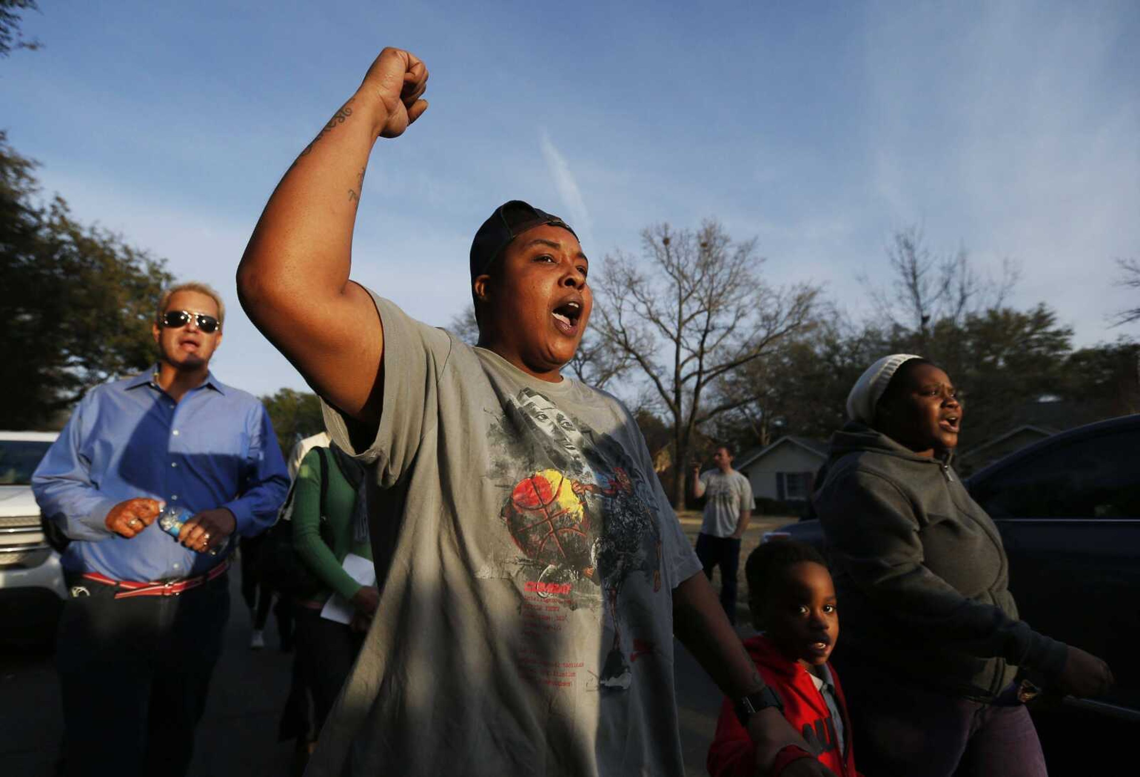 Charletteria Mathis, second from left, Albeta Wellington, far right, and her son Mark Wallace, 5, protest Wednesday outside the family home of former University of Oklahoma Sigma Alpha Epsilon fraternity member Parker Rice in Dallas. Rice and several other fraternity members were seen on video chanting a racist song. (Brandon Wade ~ Associated Press)