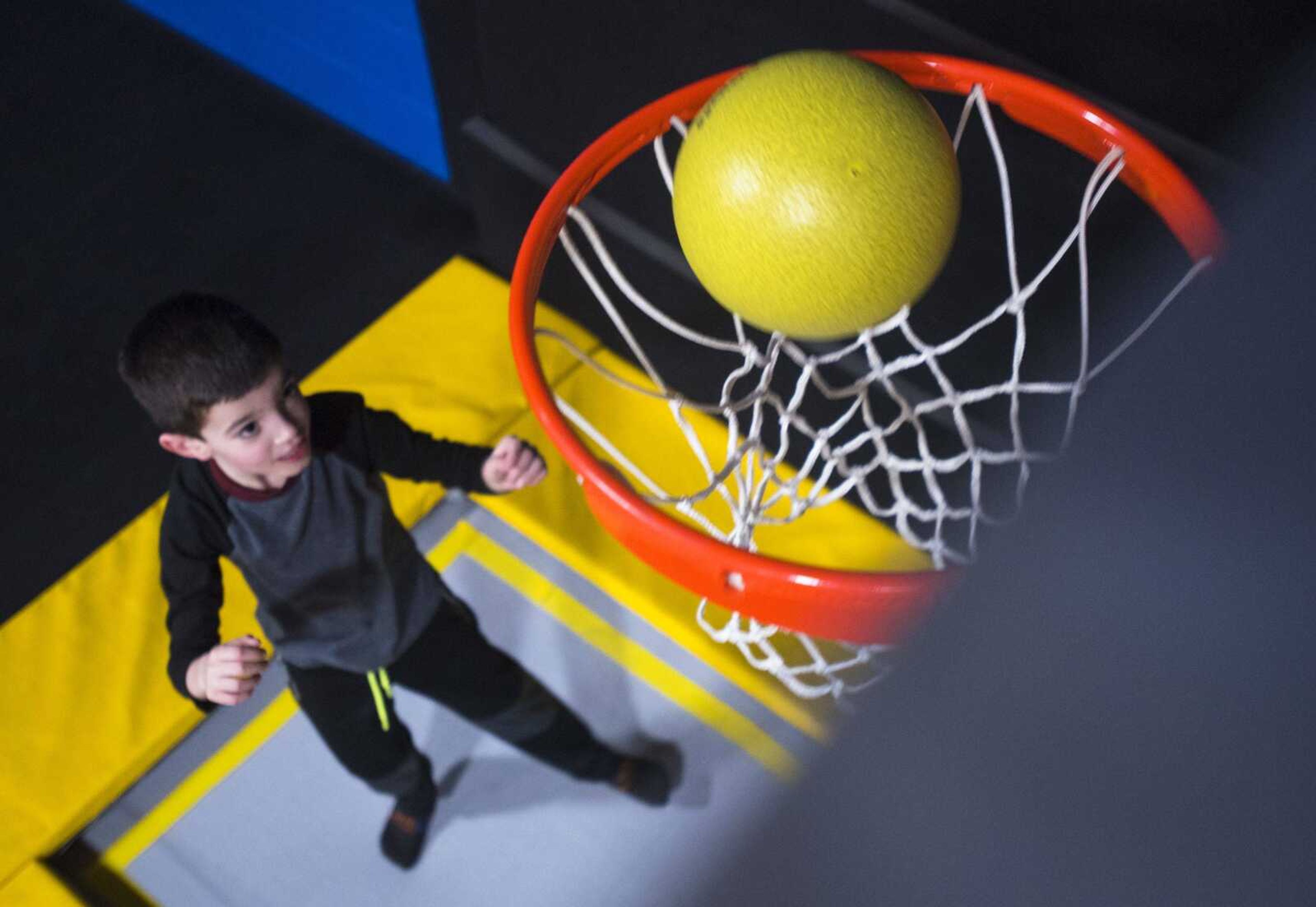 Emmett Griffin, 7, shoots a ball through a hoop Tuesday during an Easterseals Midwest monthly outing at Ultimate Air Trampoline Park in Scott City.